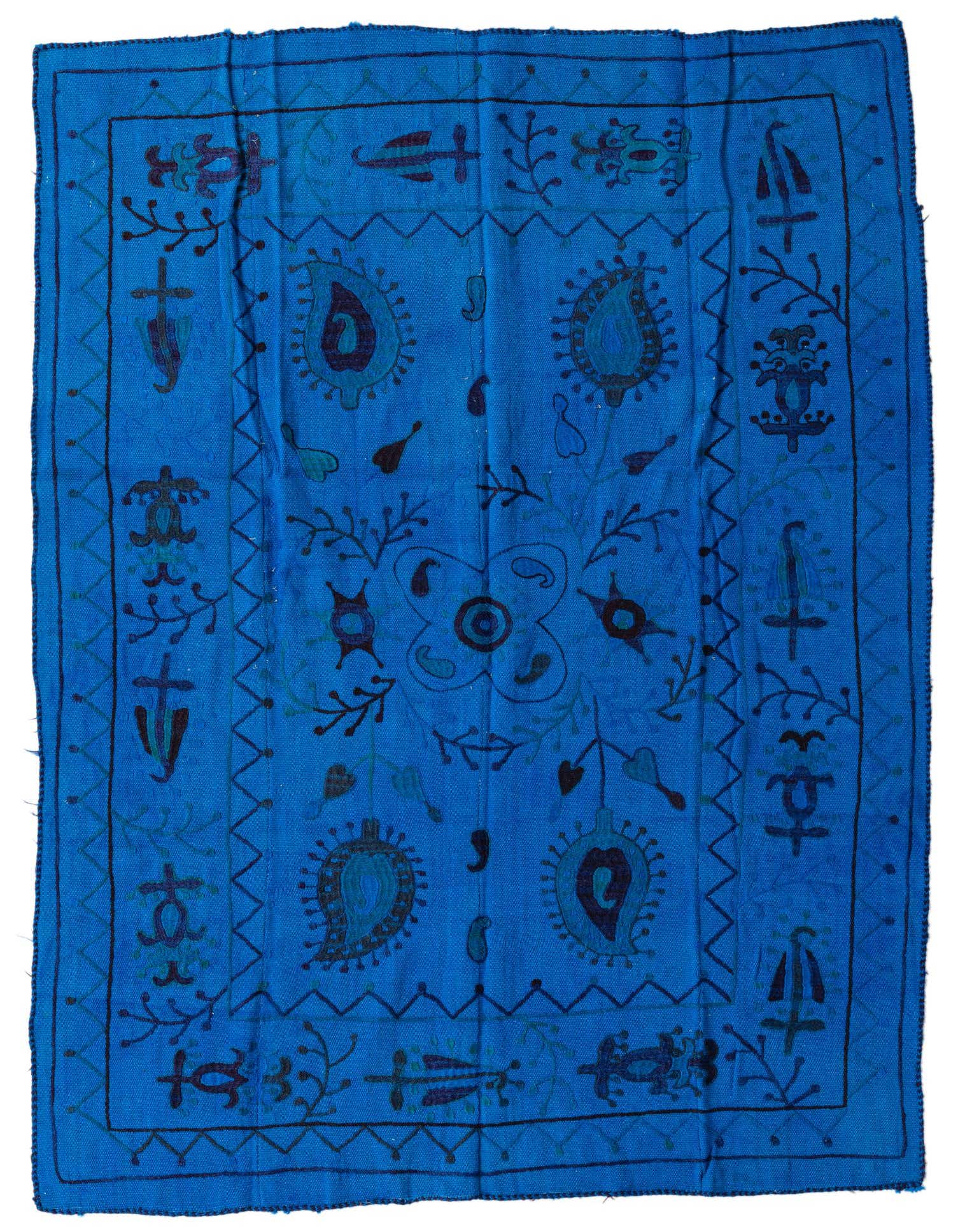 A 4x6 rectangular blue wool rug with a vibrant tribal Suzani pattern and dark blue accents.