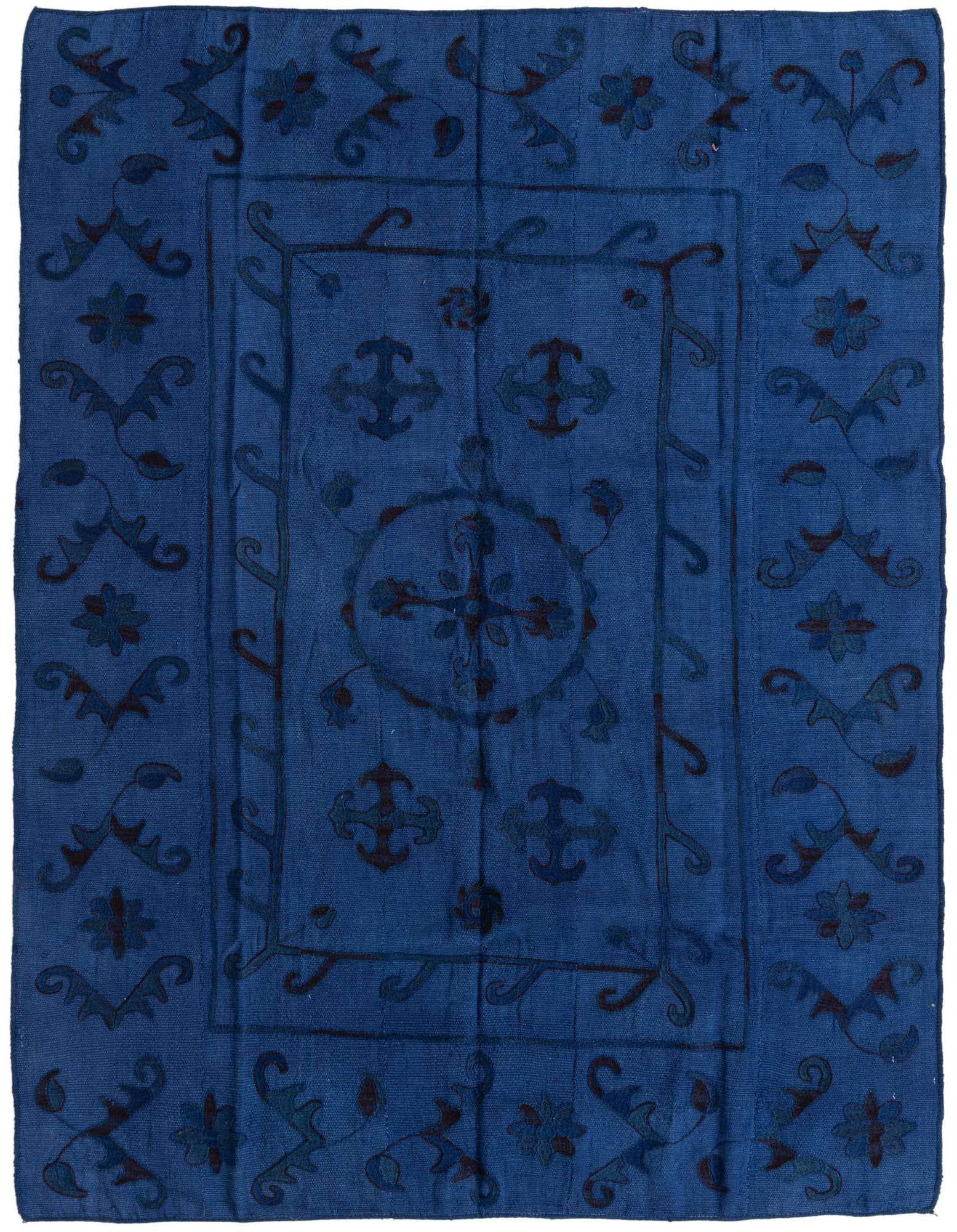 A 5x8 rectangular Kilim Suzani rug in varying shades of blue, featuring a tribal-oriental floral and medallion pattern.
