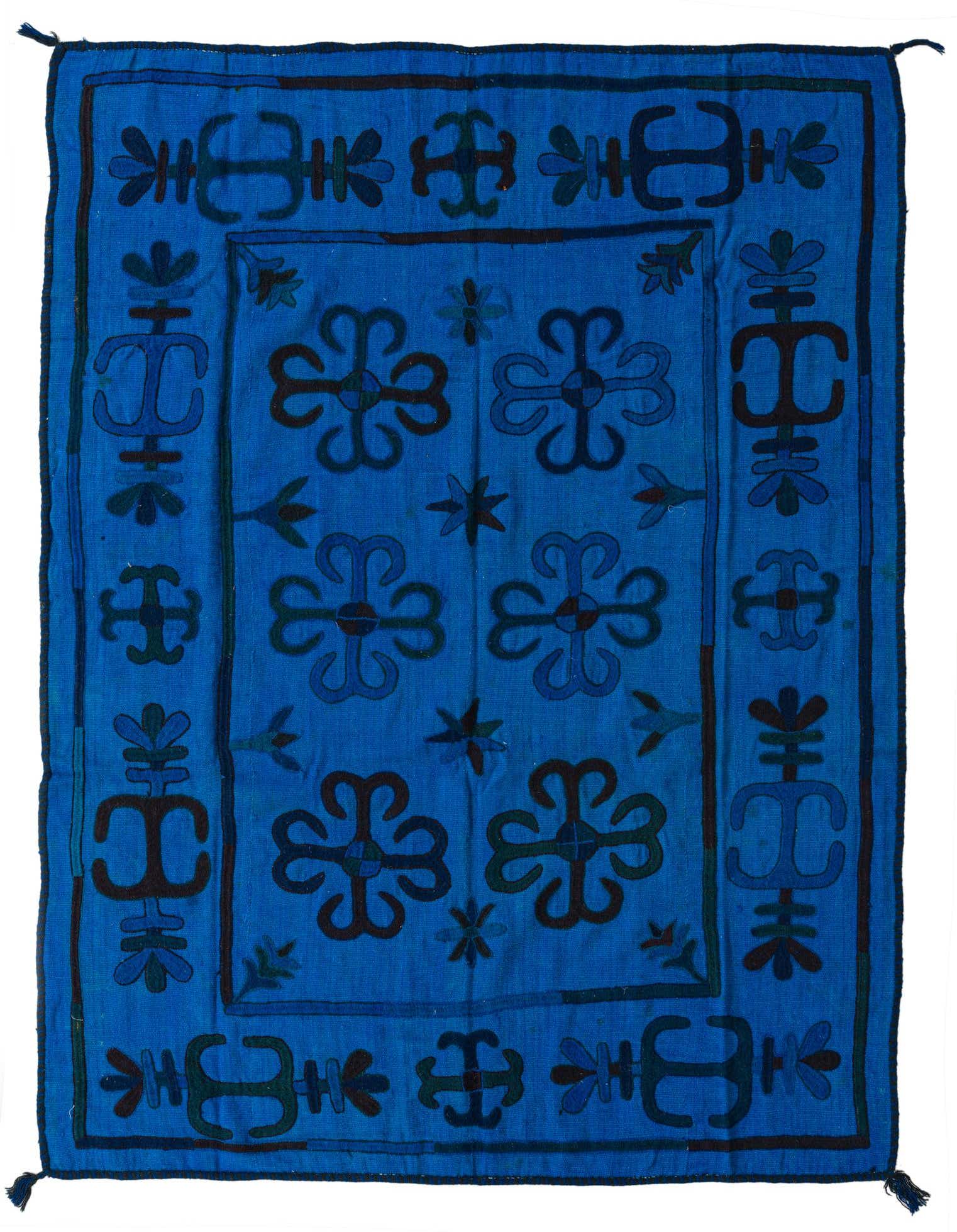 A 5x8 rectangular Kilim Suzani rug in vibrant blues, featuring a tribal pattern with geometric and floral motifs.