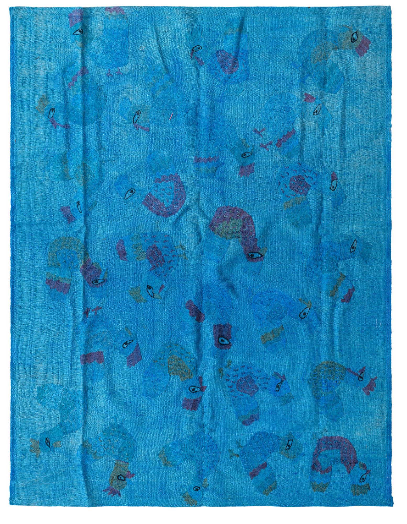 A 4x6 rectangular blue Kilim Suzani wool rug featuring a repeating tribal pattern of stylized birds in various shades of blue, red, and yellow.