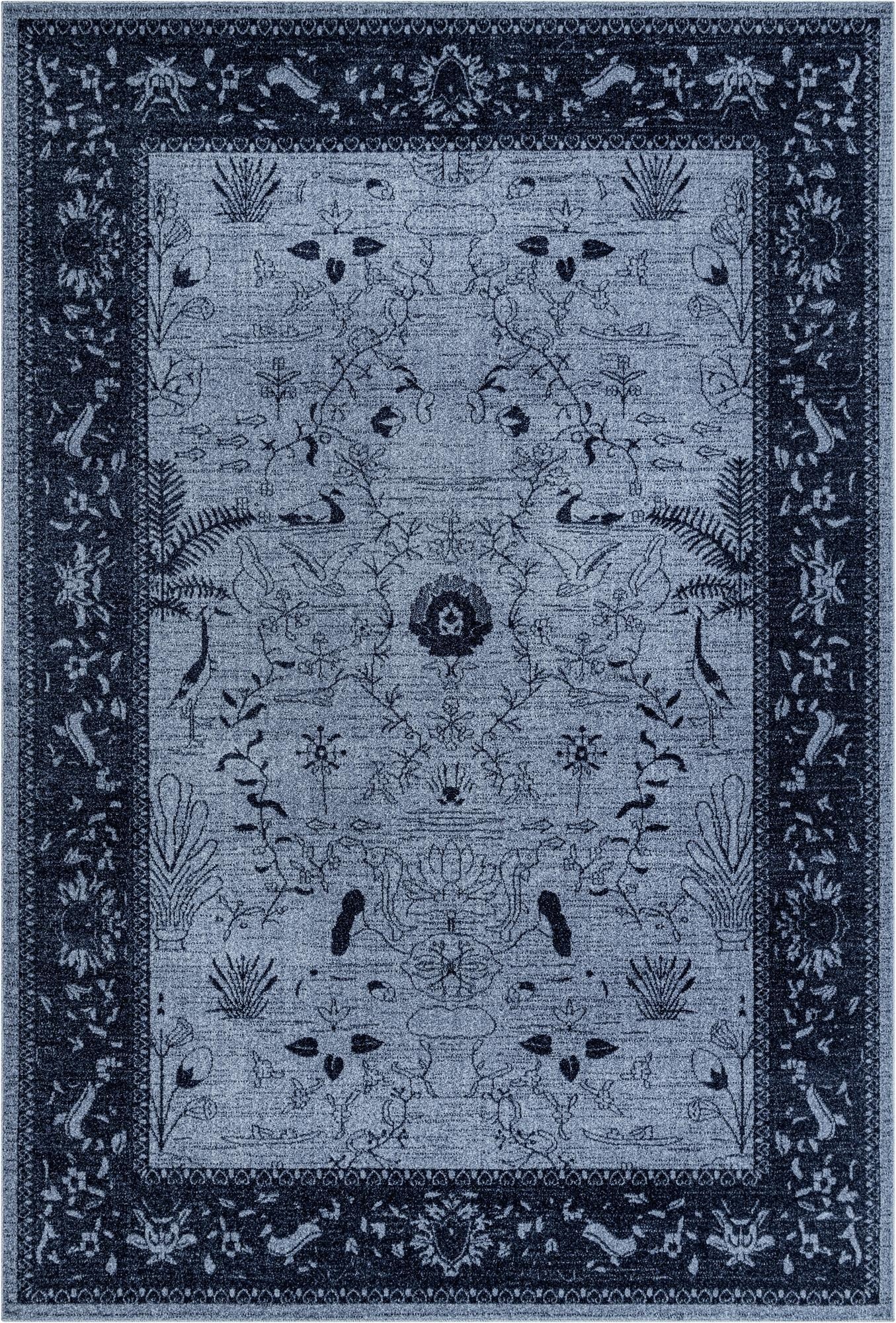 A 7x10 rectangular blue area rug with a traditional botanical pattern featuring birds and flowers, set against a lighter blue background with a darker blue border.