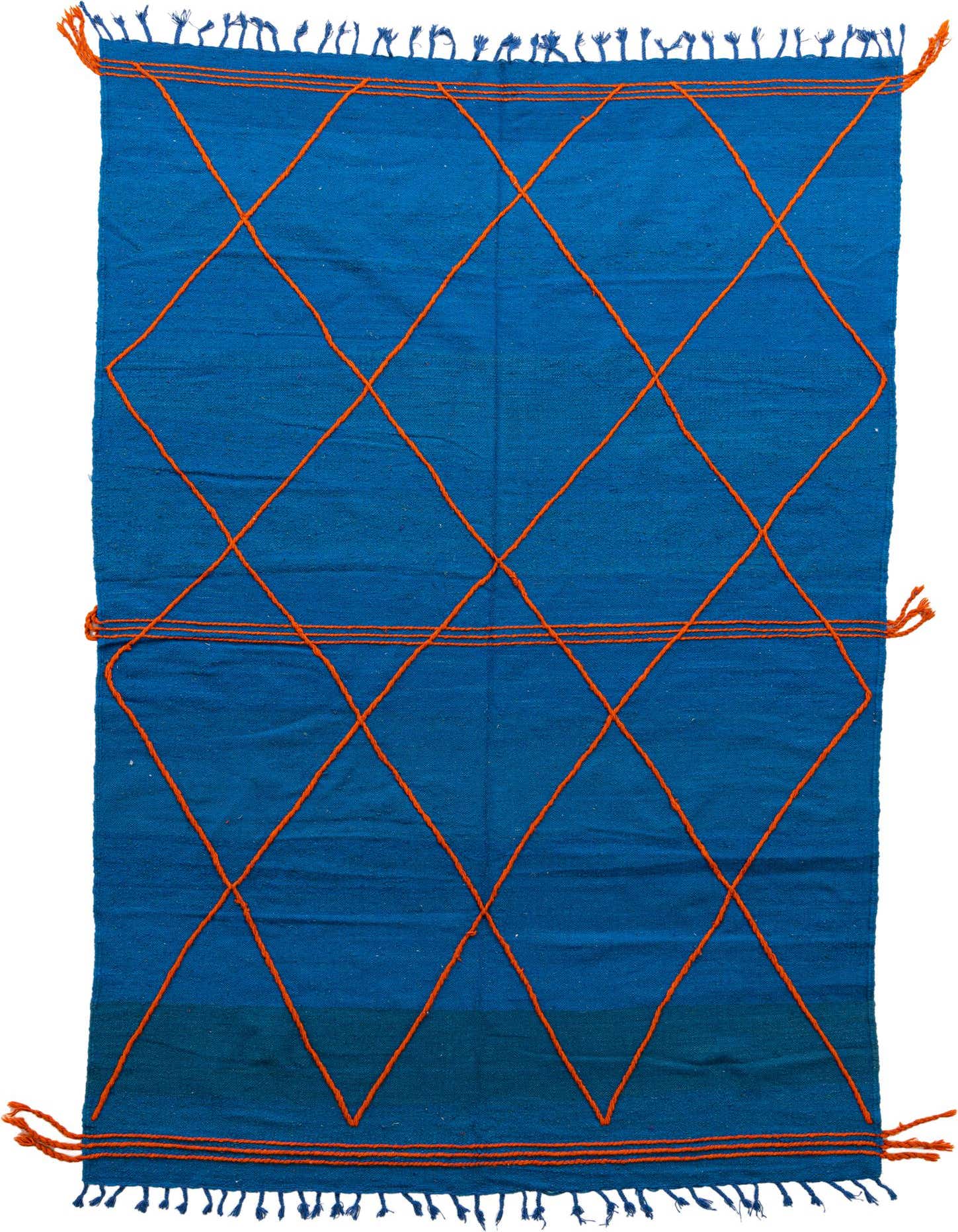 A 6x9 rectangular blue wool shag rug with an orange tribal diamond pattern and fringe.
