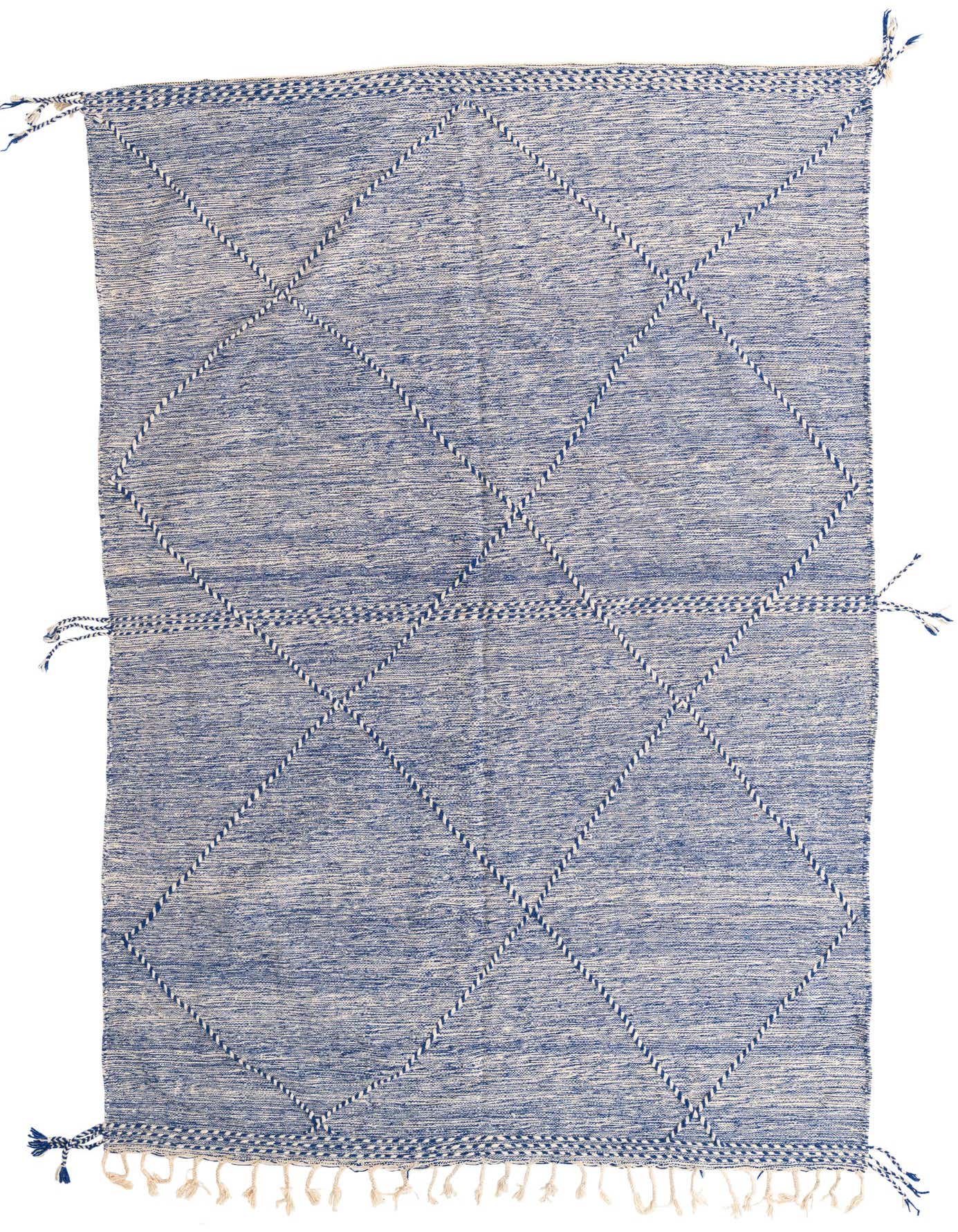 A 7x10 rectangular blue wool shag rug with a white tribal diamond pattern and tassels, perfect for a living room.