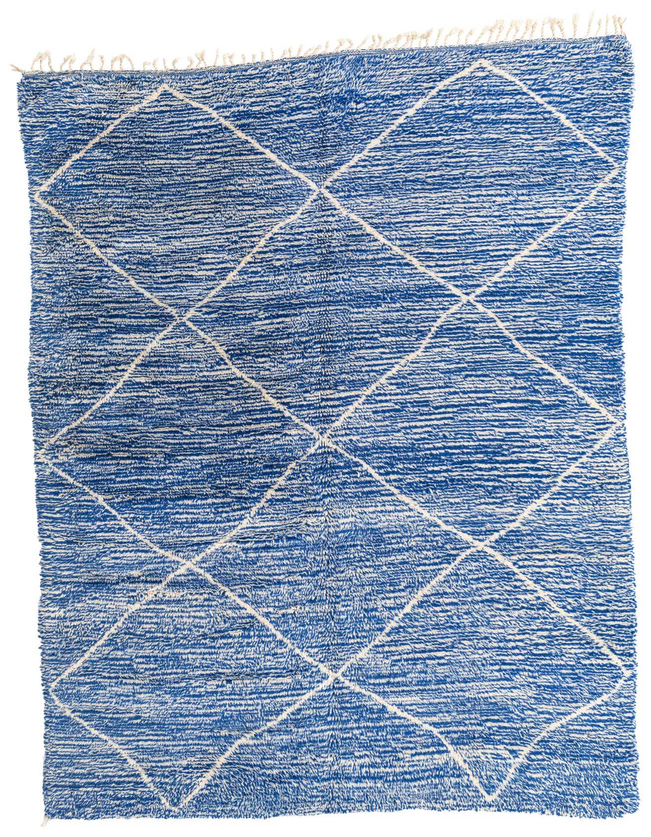 A 7x10 rectangular Moroccan shag rug in vibrant blue with a white tribal diamond pattern and fringed edges.