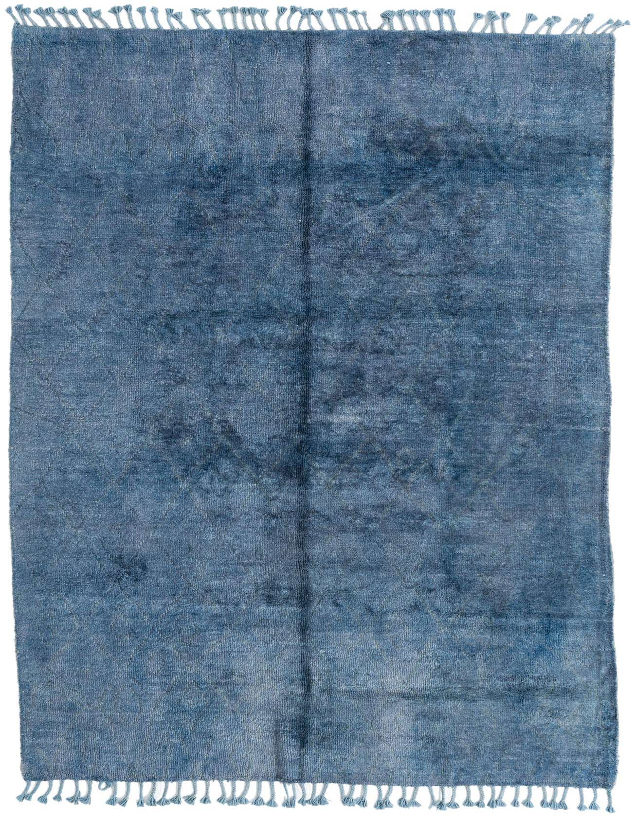 A 6x9 rectangular blue shag rug with a subtle tribal pattern and fringe, ideal for a living room.