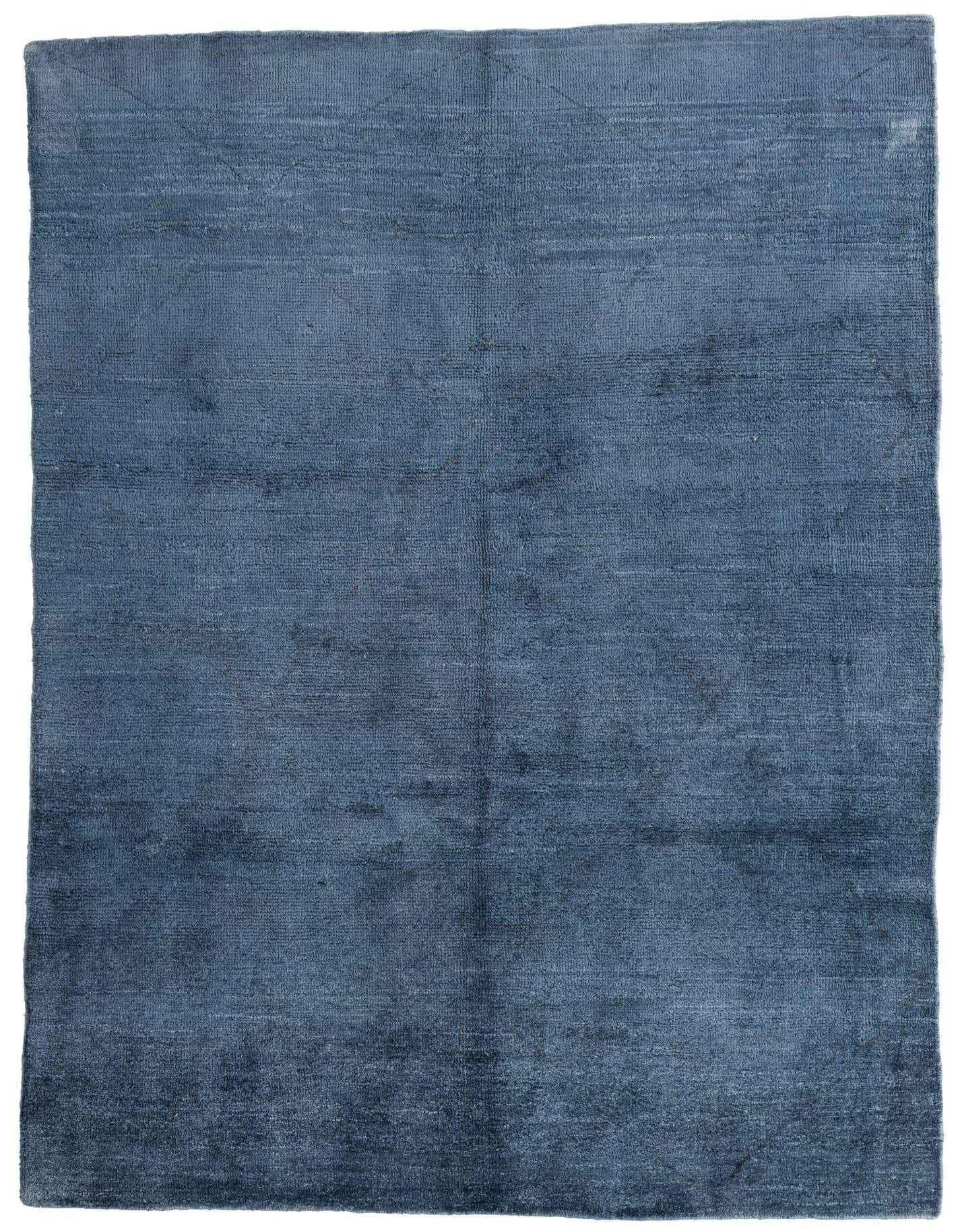 A 5x8 rectangular blue shag rug from the Moroccan collection, handmade from 100% wool, perfect for a living room.