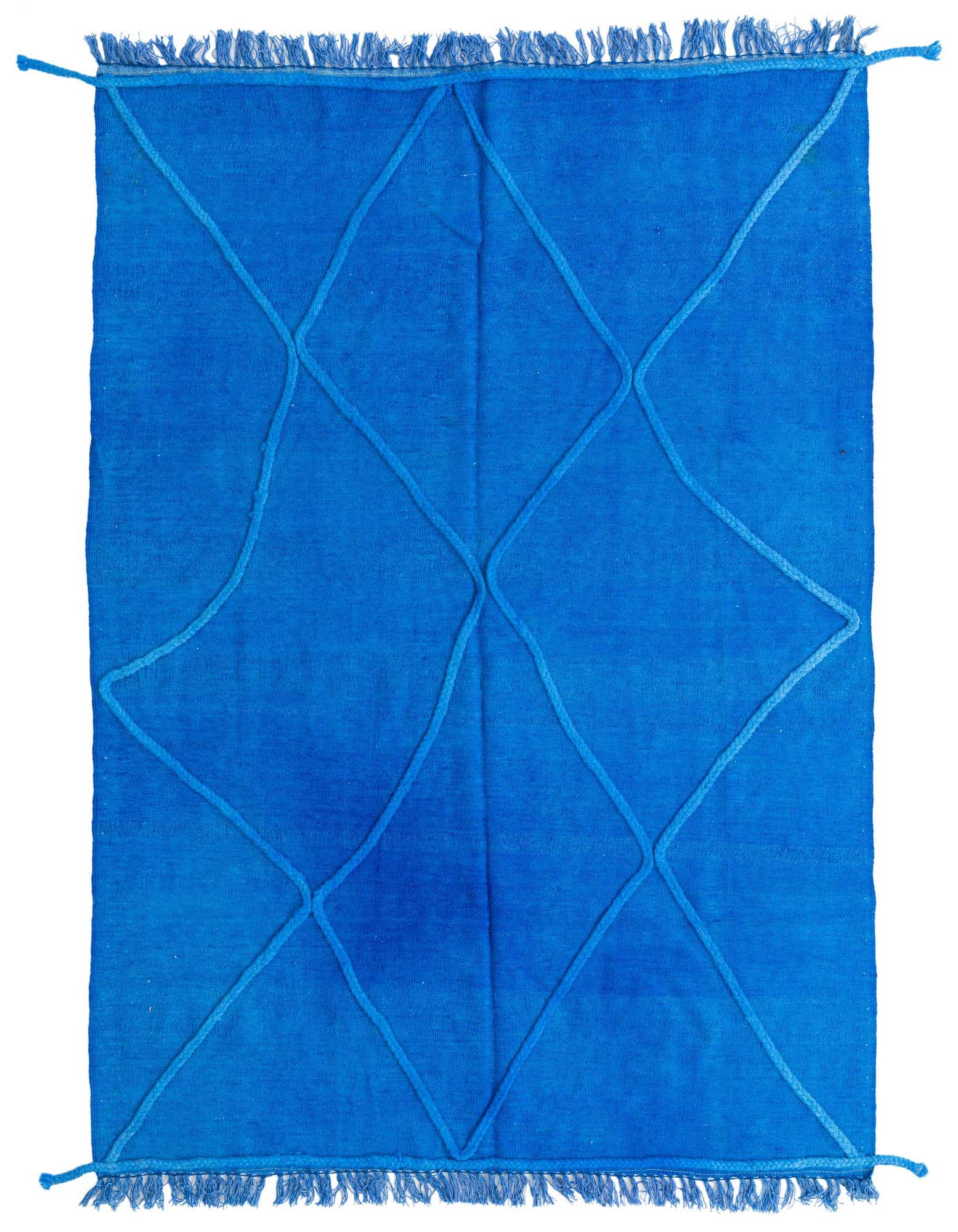 A vibrant 4x6 rectangular blue shag rug with a raised geometric diamond pattern and fringed edges, perfect for a modern living room.