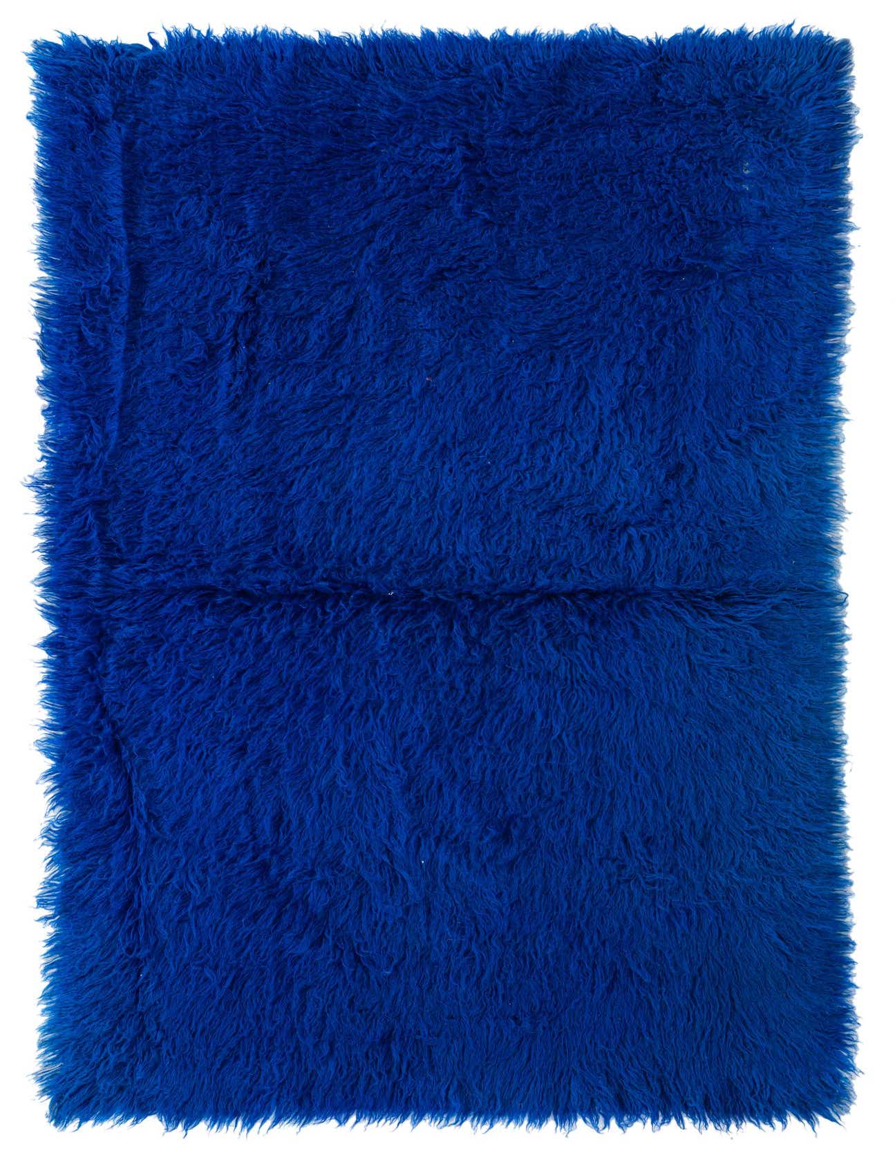 A vibrant 4x6 rectangular blue shag rug with a thick, plush pile, ideal for a modern living room.