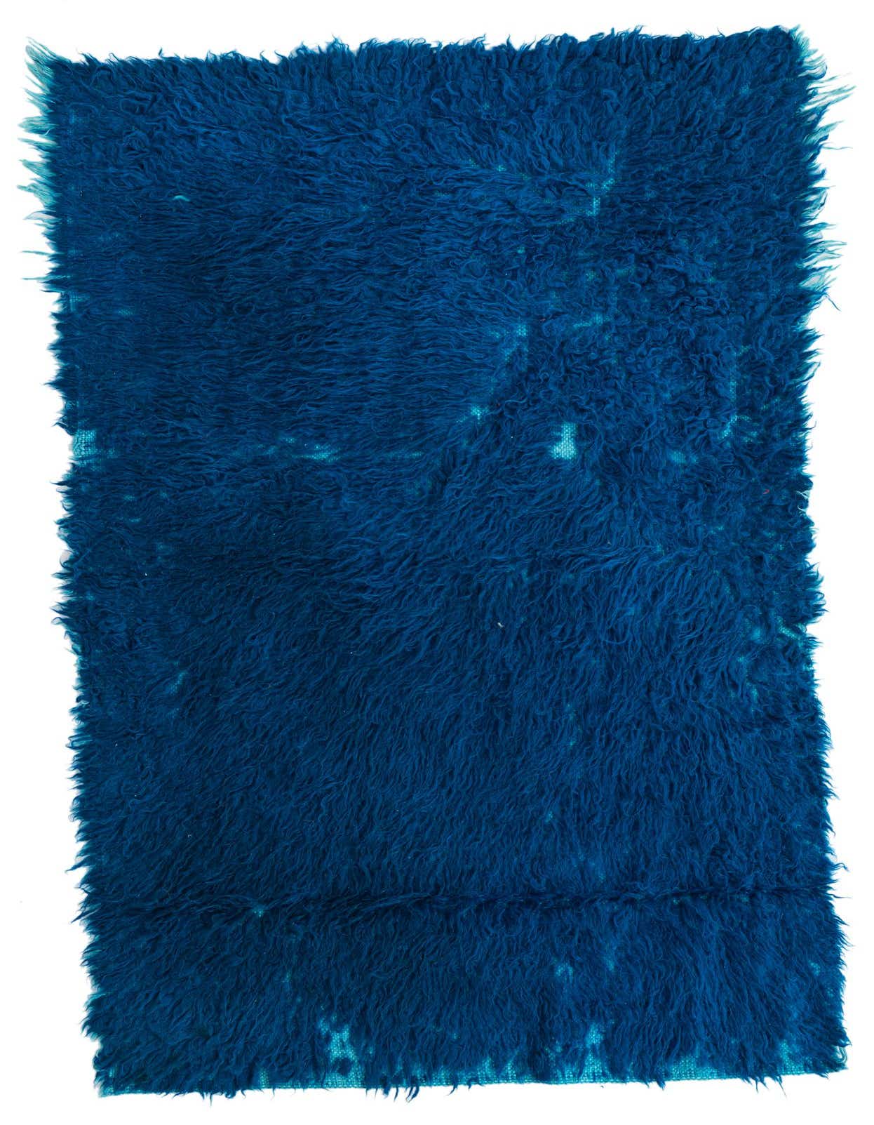 A 3x5 rectangular shag rug in deep blue, featuring a subtle tribal pattern, ideal for indoor spaces.