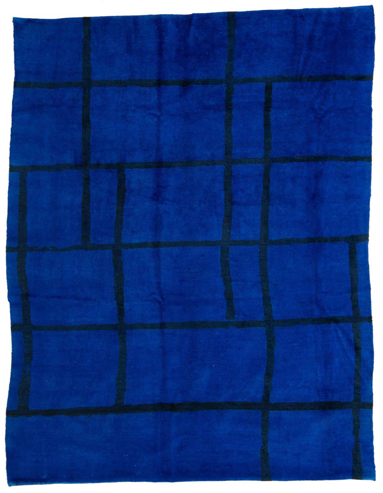 A 7x10 rectangular blue shag rug with a modern tribal grid pattern in darker blue, suitable for a living room.