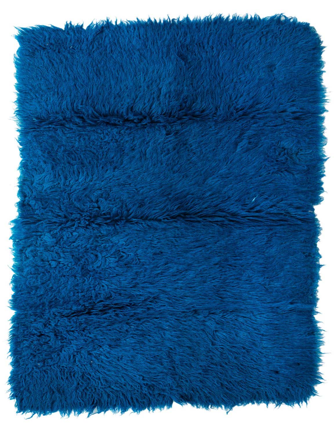 A rectangular 3x5 blue shag rug with a thick, plush pile, handmade from 100% wool.