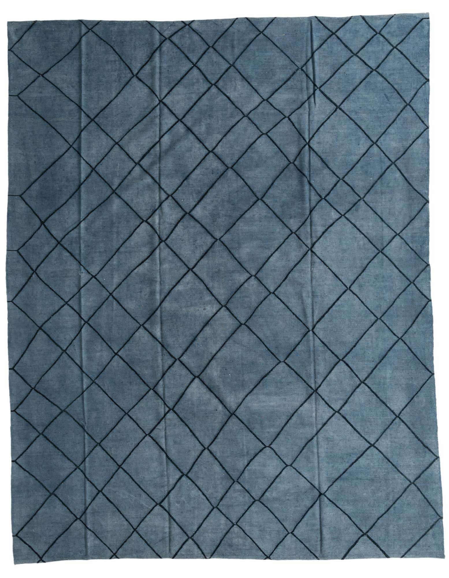 A 10x13 rectangular blue shag rug featuring a modern tribal diamond pattern in darker blue, suitable for a living room.