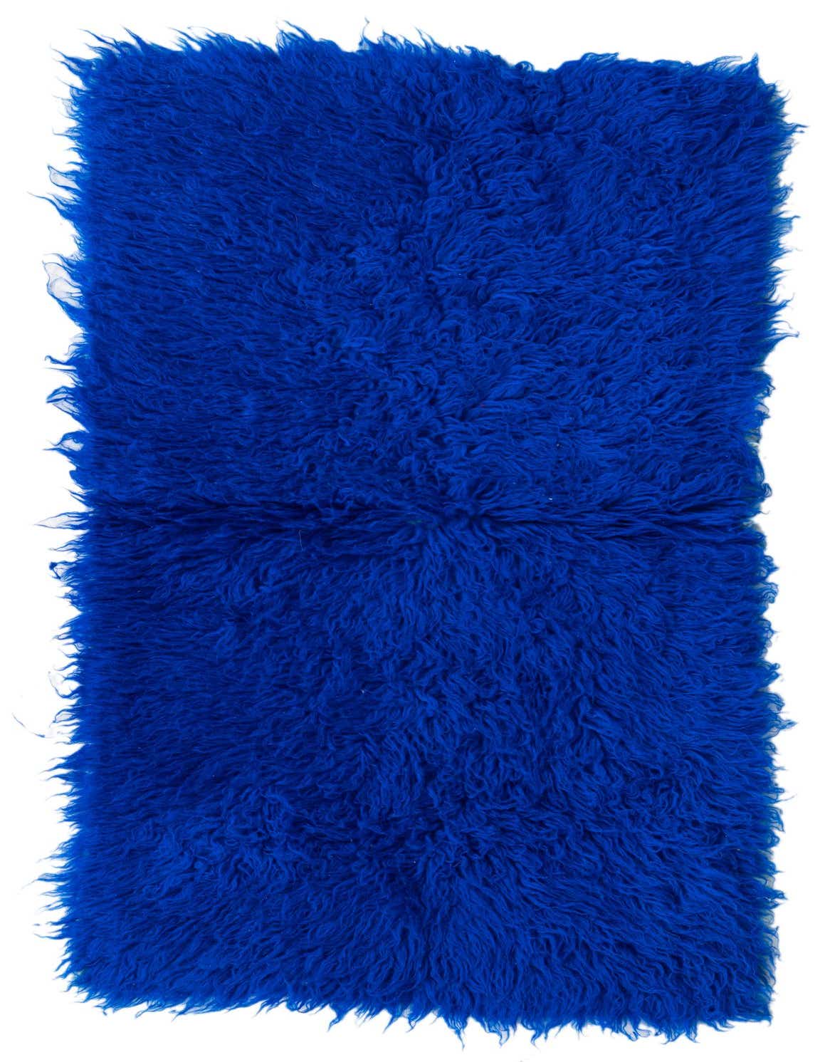 A vibrant 2x3 rectangular blue shag rug with a thick, plush wool pile, perfect for adding texture.