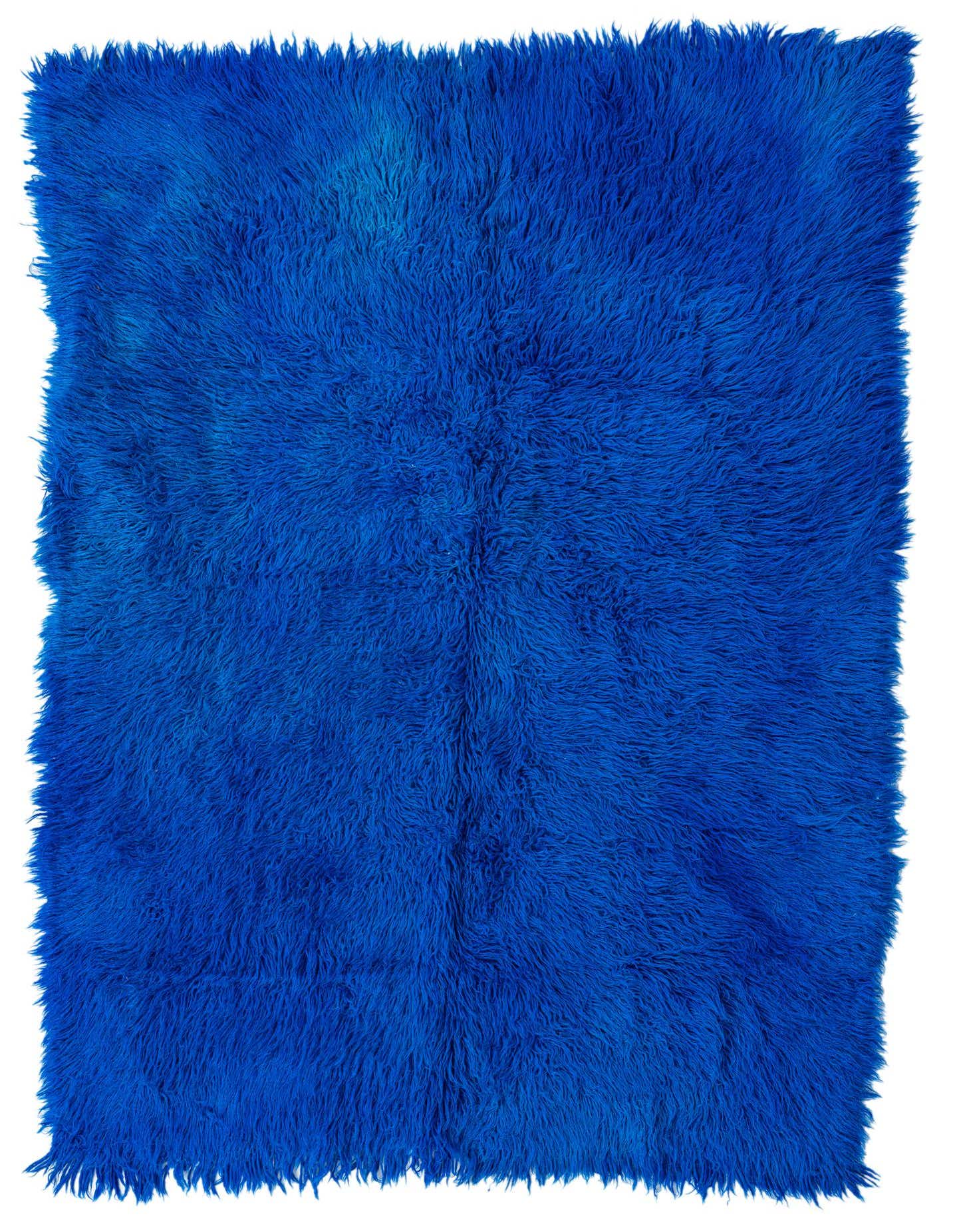 A vibrant 5x8 rectangular blue shag rug with a thick, plush pile, perfect for a modern living room.