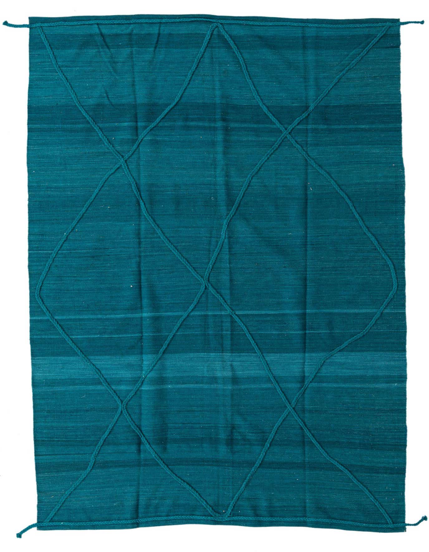 A 7x10 rectangular blue wool shag rug with a modern tribal diamond pattern made from raised braided lines.