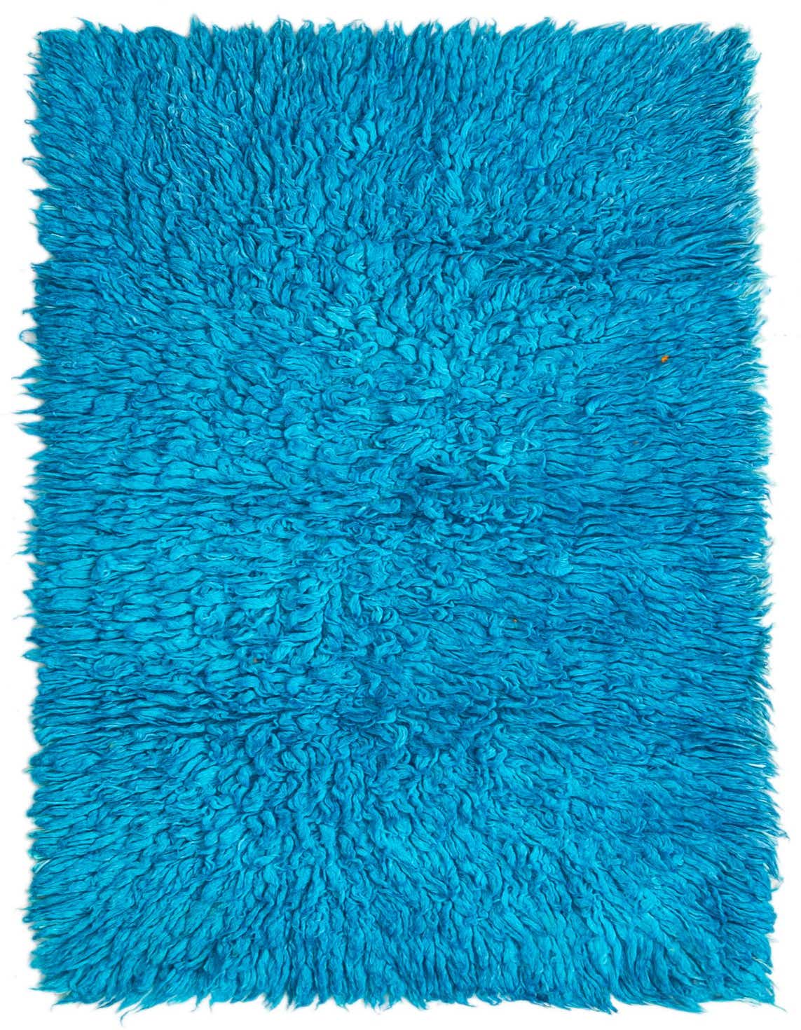 A vibrant blue 3x5 rectangular shag rug, handmade from wool, featuring a plush, textured pile.