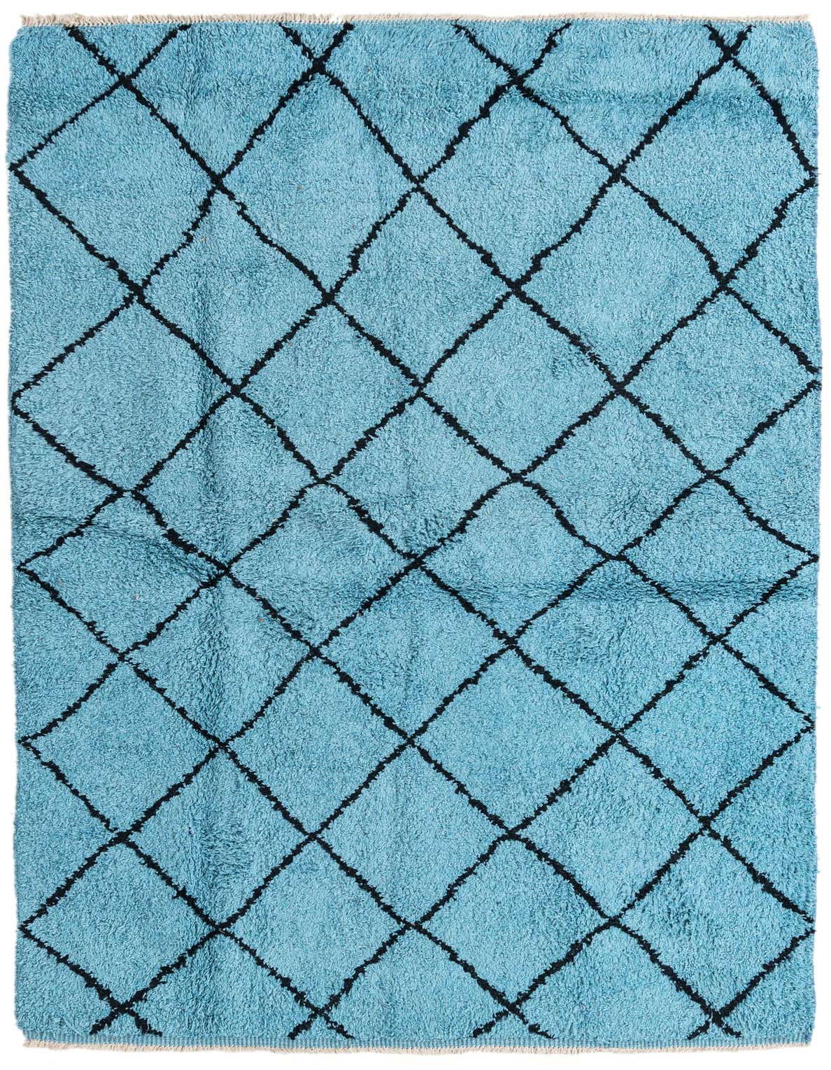 A rectangular 5x8 blue shag rug with a black tribal diamond pattern, ideal for a modern living room.