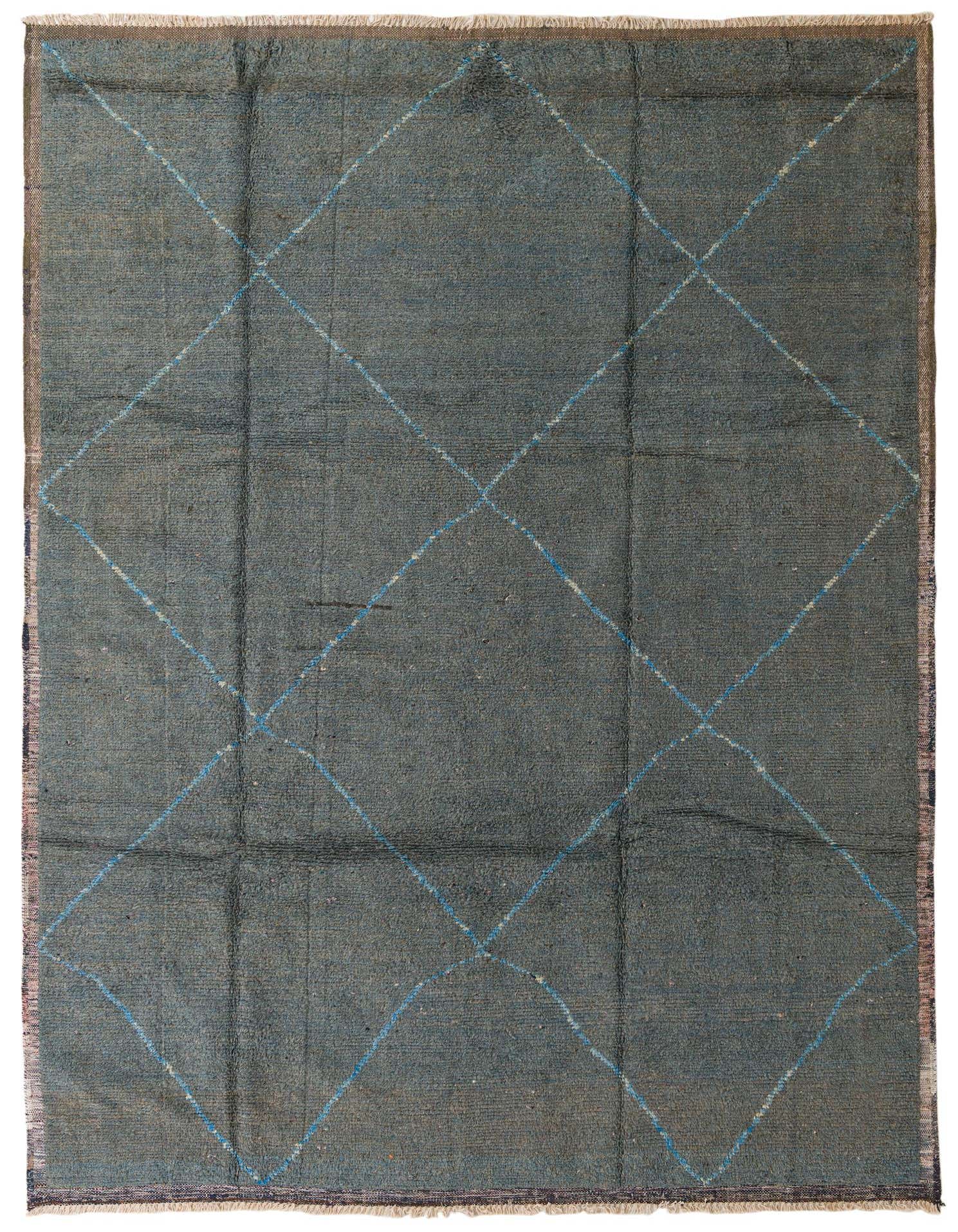 A 9x12 rectangular blue shag rug with a subtle tribal diamond pattern in lighter blue, suitable for a living room.