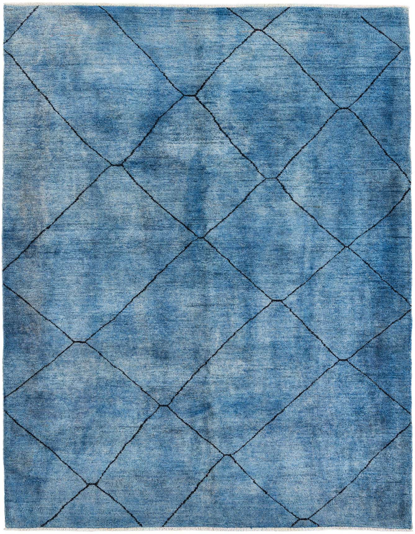A 7x10 rectangular blue shag rug with a modern tribal black diamond pattern, ideal for a living room.