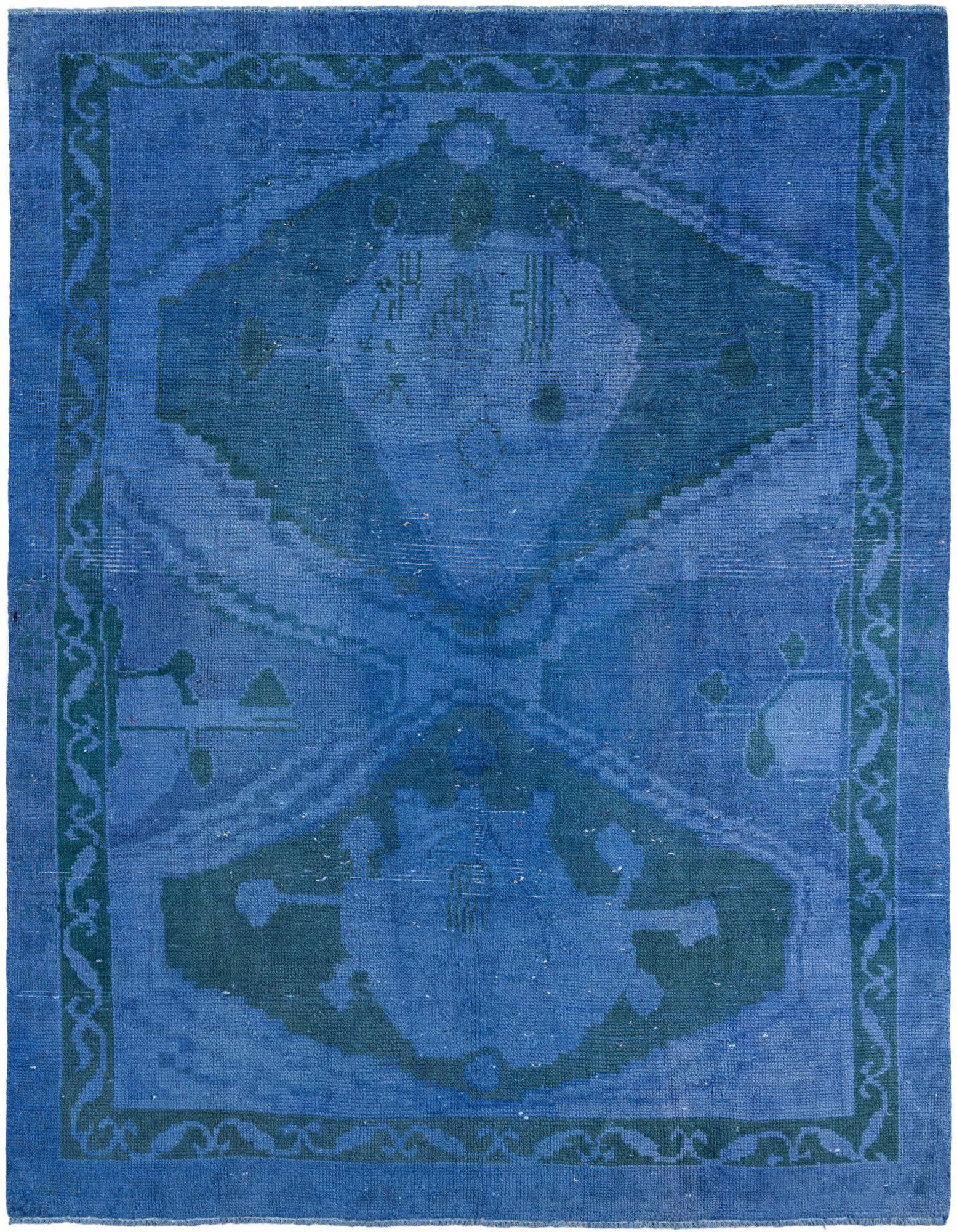 A 7x10 rectangular blue wool shag rug with a faded tribal pattern and a darker blue border.
