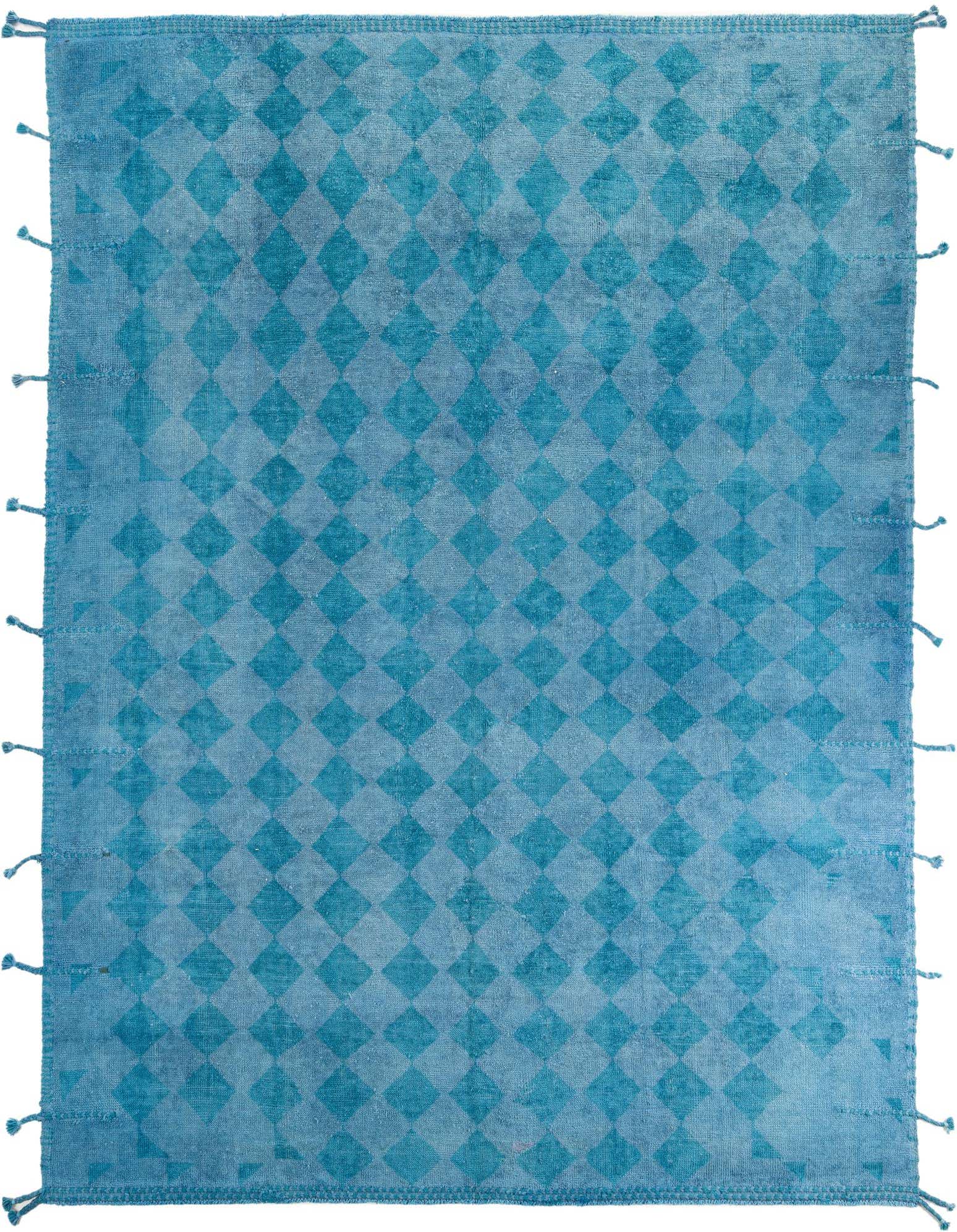 A 9x12 rectangular blue wool shag rug with a faded tribal diamond pattern and tassels, perfect for a modern living room.