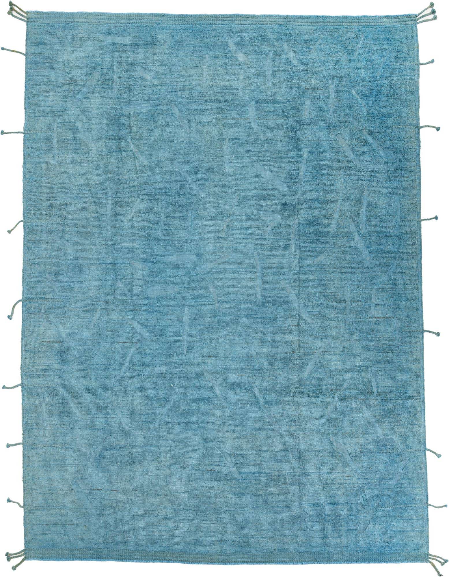 A 9x12 rectangular blue shag rug with a subtle abstract tribal pattern and knotted fringes on a white background.