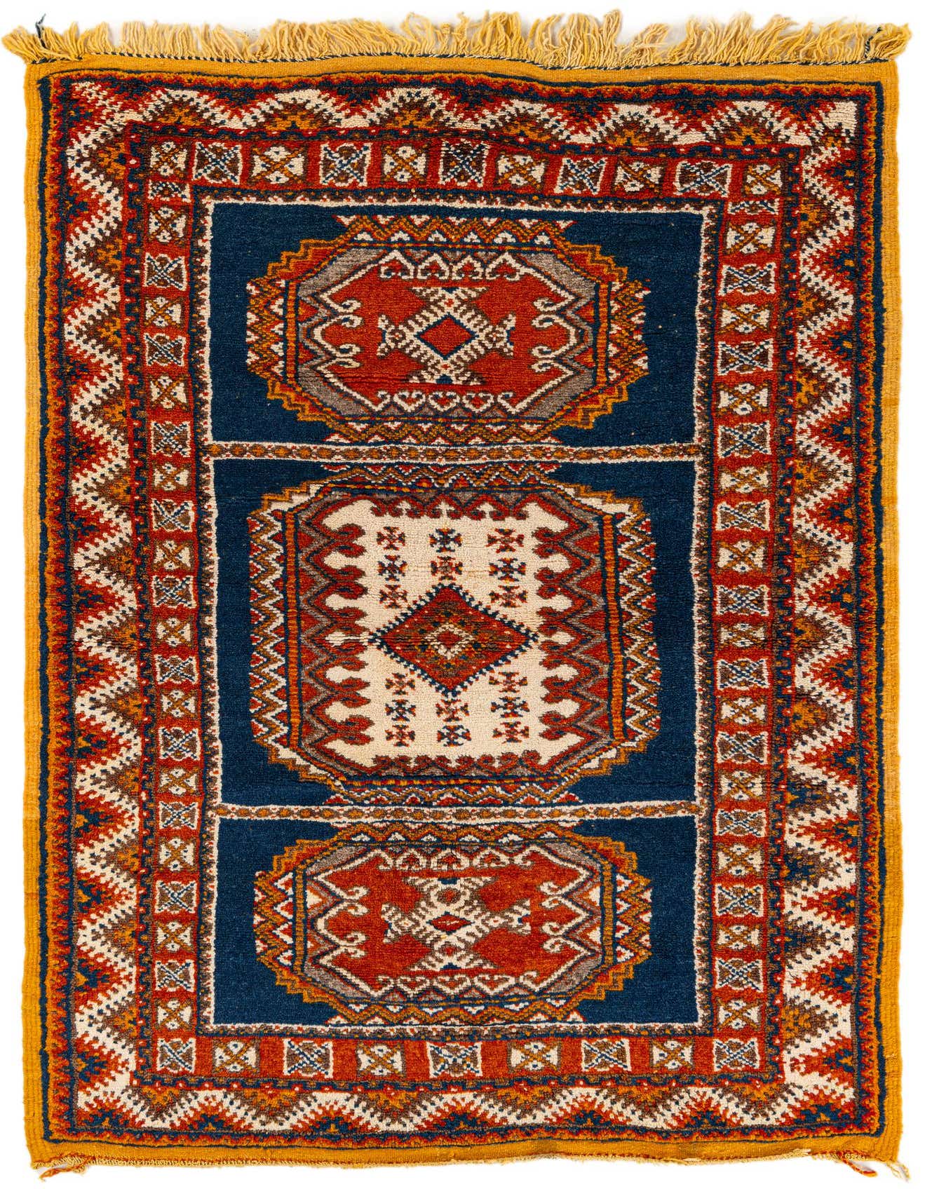 A 4x6 rectangular Moroccan shag rug with a deep blue background, featuring traditional tribal medallions in rust, cream, and brown, with yellow fringe.