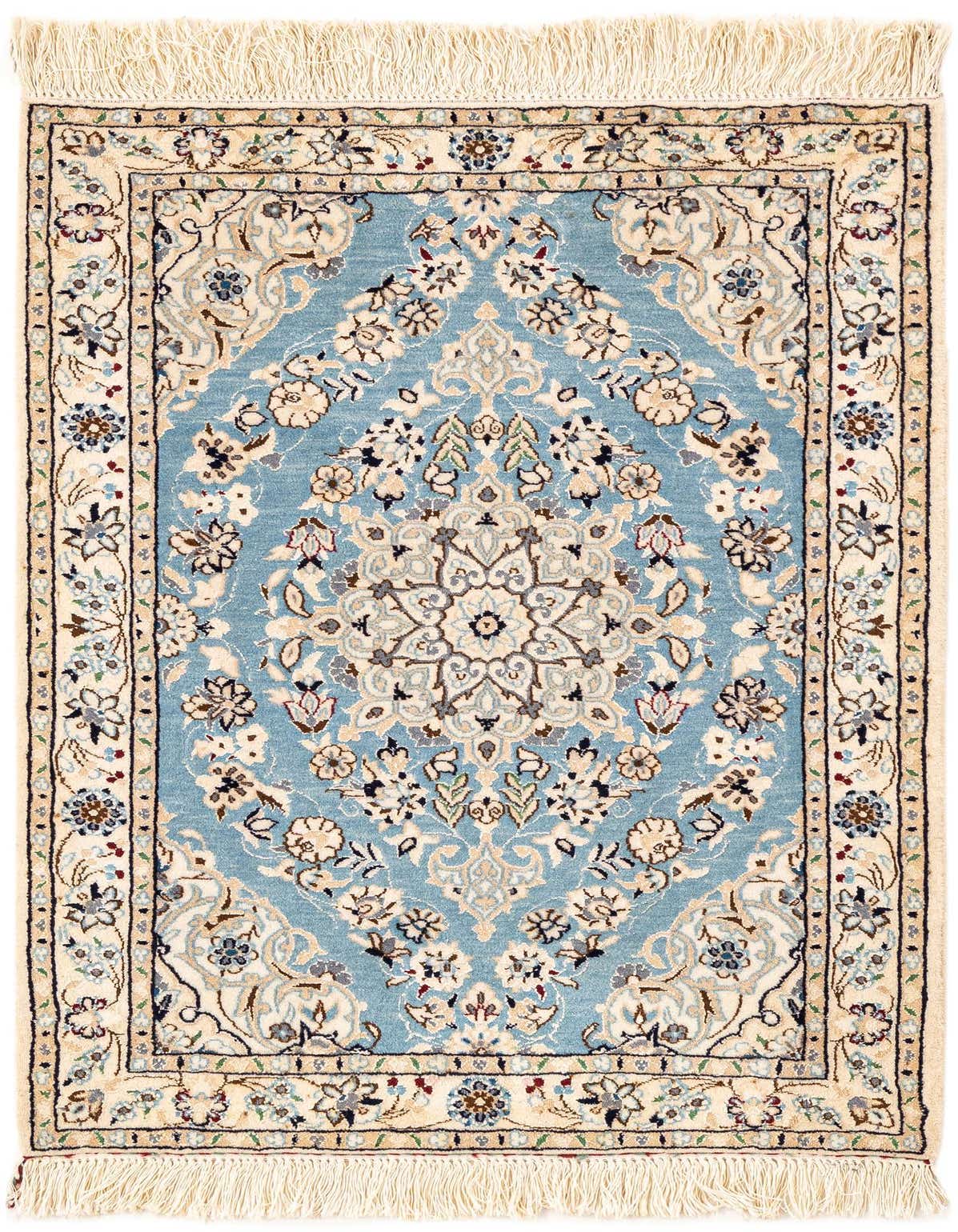 A handmade rectangular Persian rug featuring a central medallion and intricate floral patterns in shades of blue, cream, and subtle accents, with fringed ends.