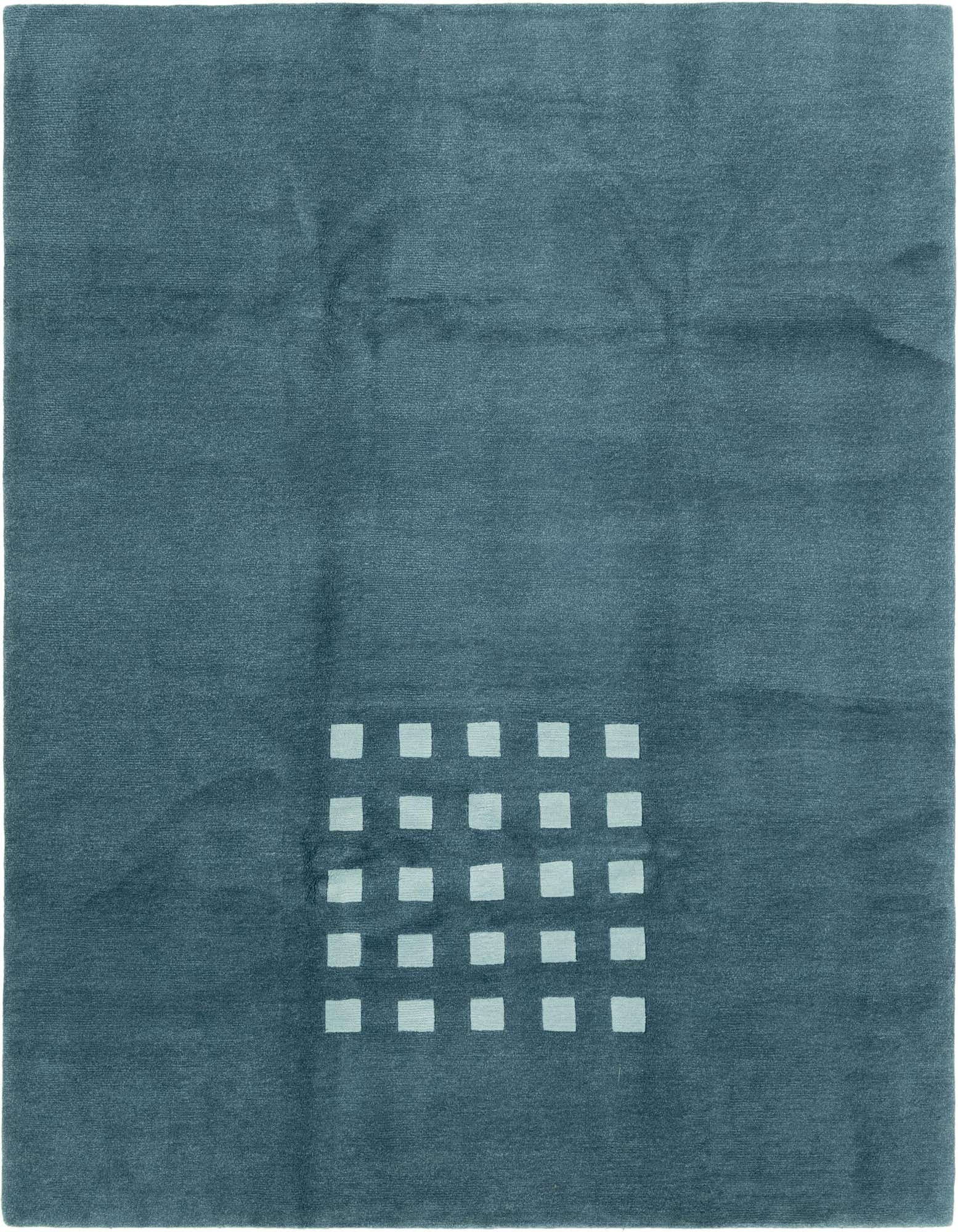 A rectangular 8x10 blue wool rug with a modern abstract pattern of light blue squares clustered in one corner.