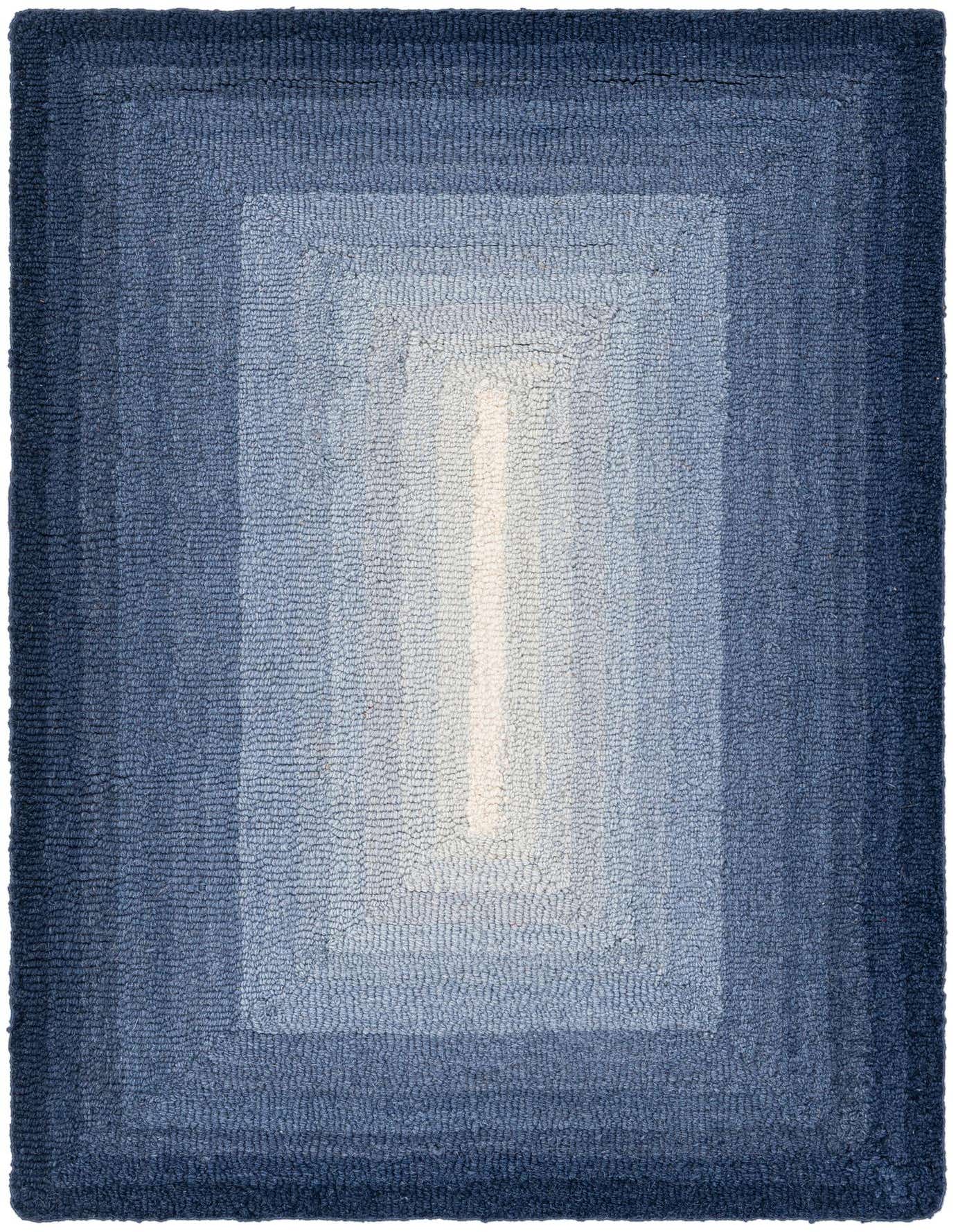 A rectangular 2x3 blue wool rug featuring an ombre pattern that transitions from dark blue edges to a light blue center.