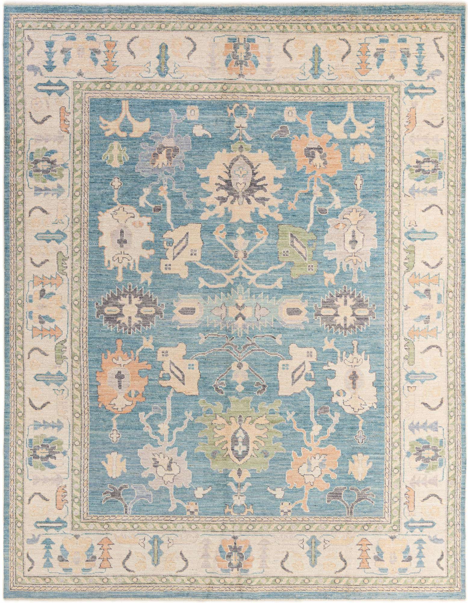 A 9x12 rectangular Oushak rug in shades of blue with a modern floral pattern and an ornate border.