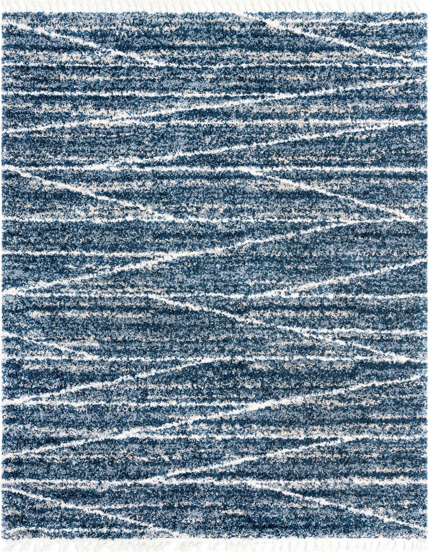 A 9x12 rectangular Serenity Shag rug with a textured blue background and abstract white stripes, ideal for a modern living room.