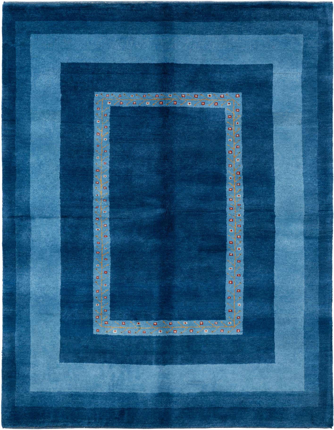 A 5x7 rectangular Rugs.com Tibet rug in varying shades of blue, featuring a modern border with subtle oriental accents.