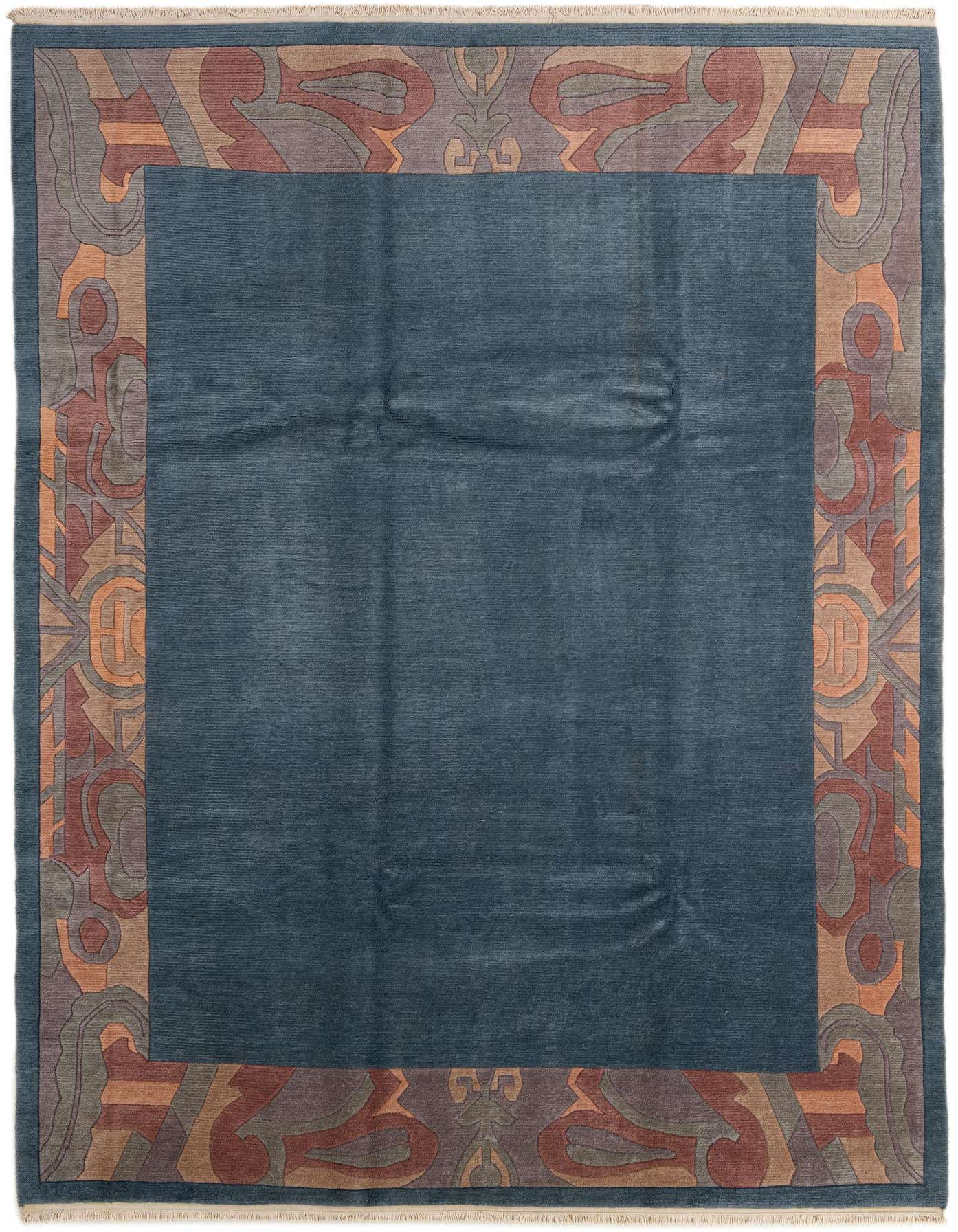 A rectangular 8x12 blue wool rug featuring a wide border with abstract, oriental-inspired patterns in shades of brown, orange, and gray.