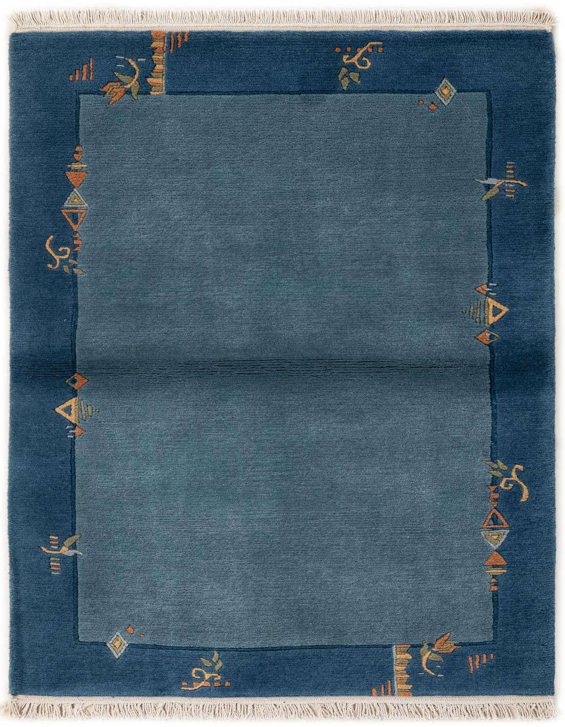 A 3x5 rectangular blue wool rug with a darker blue border featuring abstract oriental motifs in orange, green, and yellow.
