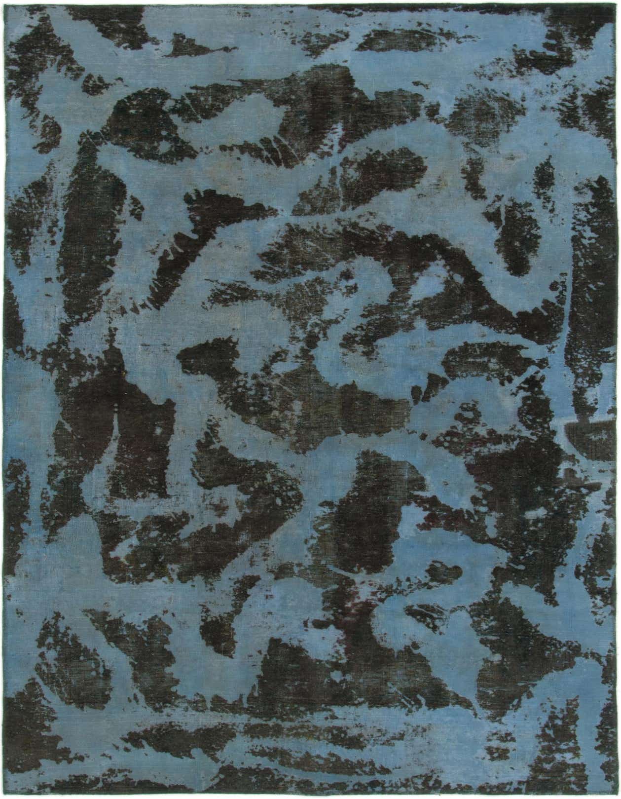 A 6x9 rectangular blue wool rug with an abstract, distressed black pattern, suitable for a living room.