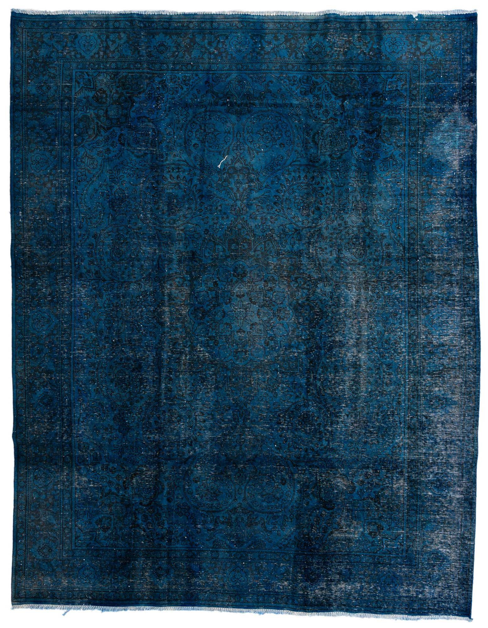 A large 10x13 rectangular blue Persian rug with a faded, distressed vintage pattern and fringe edges.