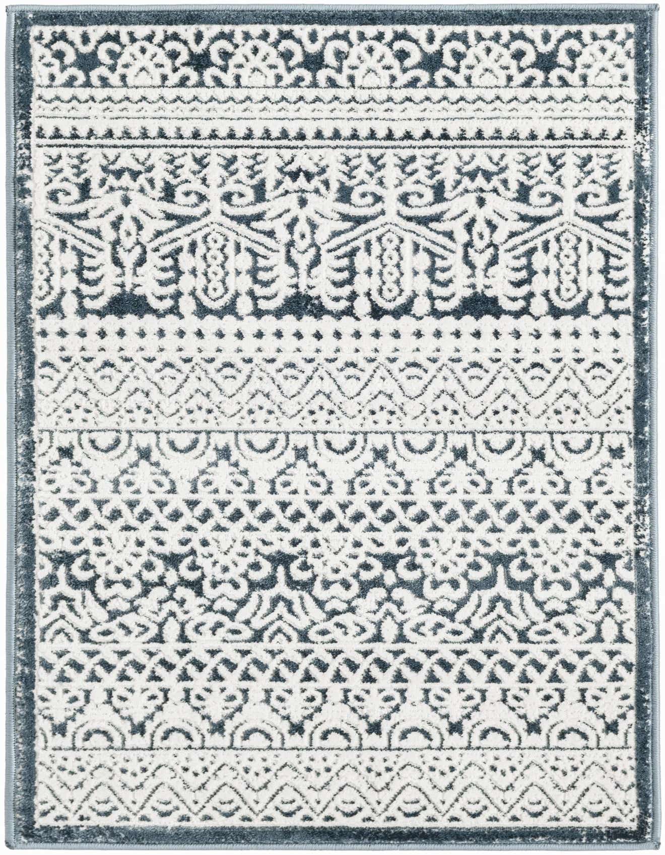 A 2x3 rectangular Uptown rug in shades of blue and white, featuring a distressed Oriental and striped pattern.