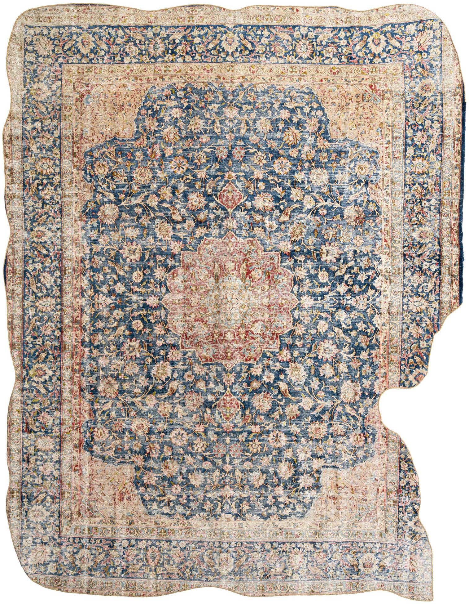 A large 9x12 rectangular Persian rug with a faded blue background, intricate floral patterns, and a central medallion in muted reds and creams.