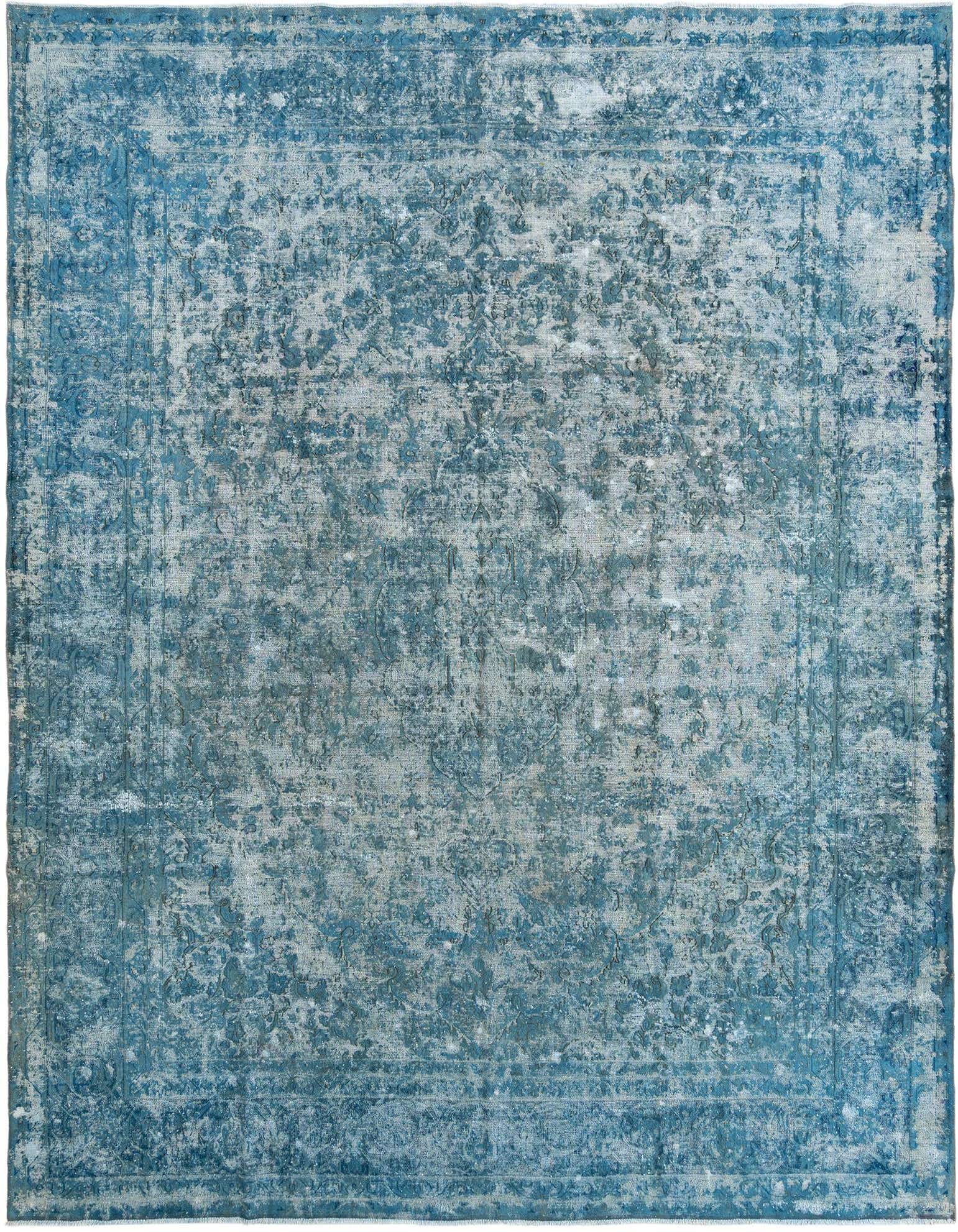 A 10x13 rectangular blue Persian-style wool rug with a distressed, faded pattern, ideal for a living room.