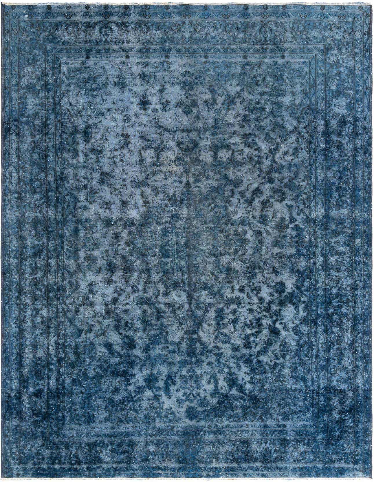 A large 9x12 rectangular blue Persian wool rug with a distressed, intricate floral pattern and a classic border.