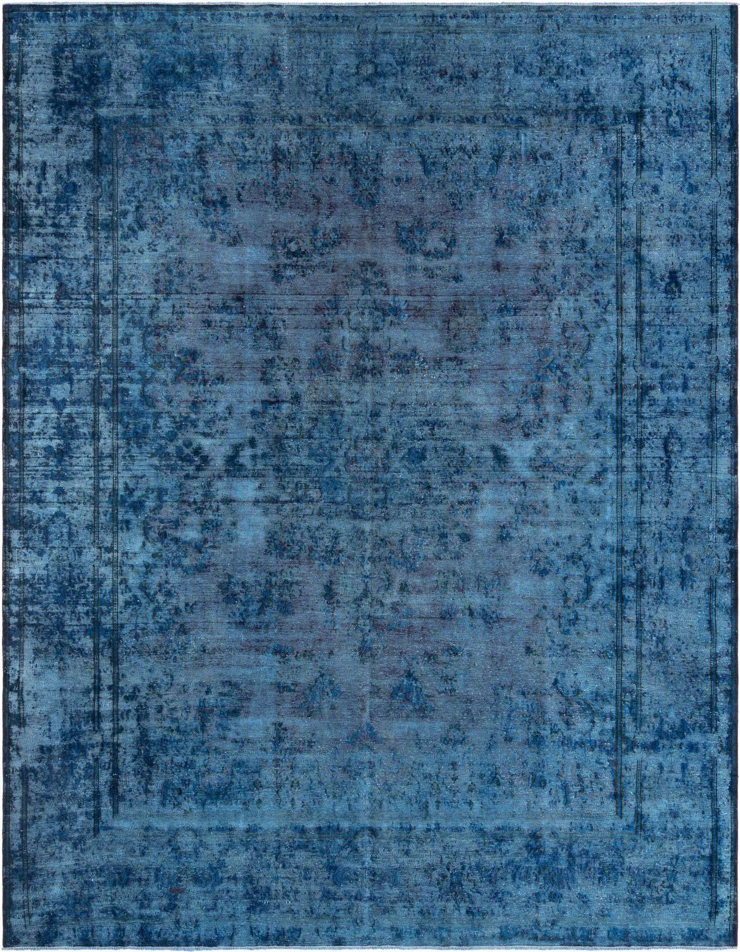 A large 10x13 rectangular blue Persian wool rug with a distressed, vintage-style floral pattern and subtle border.