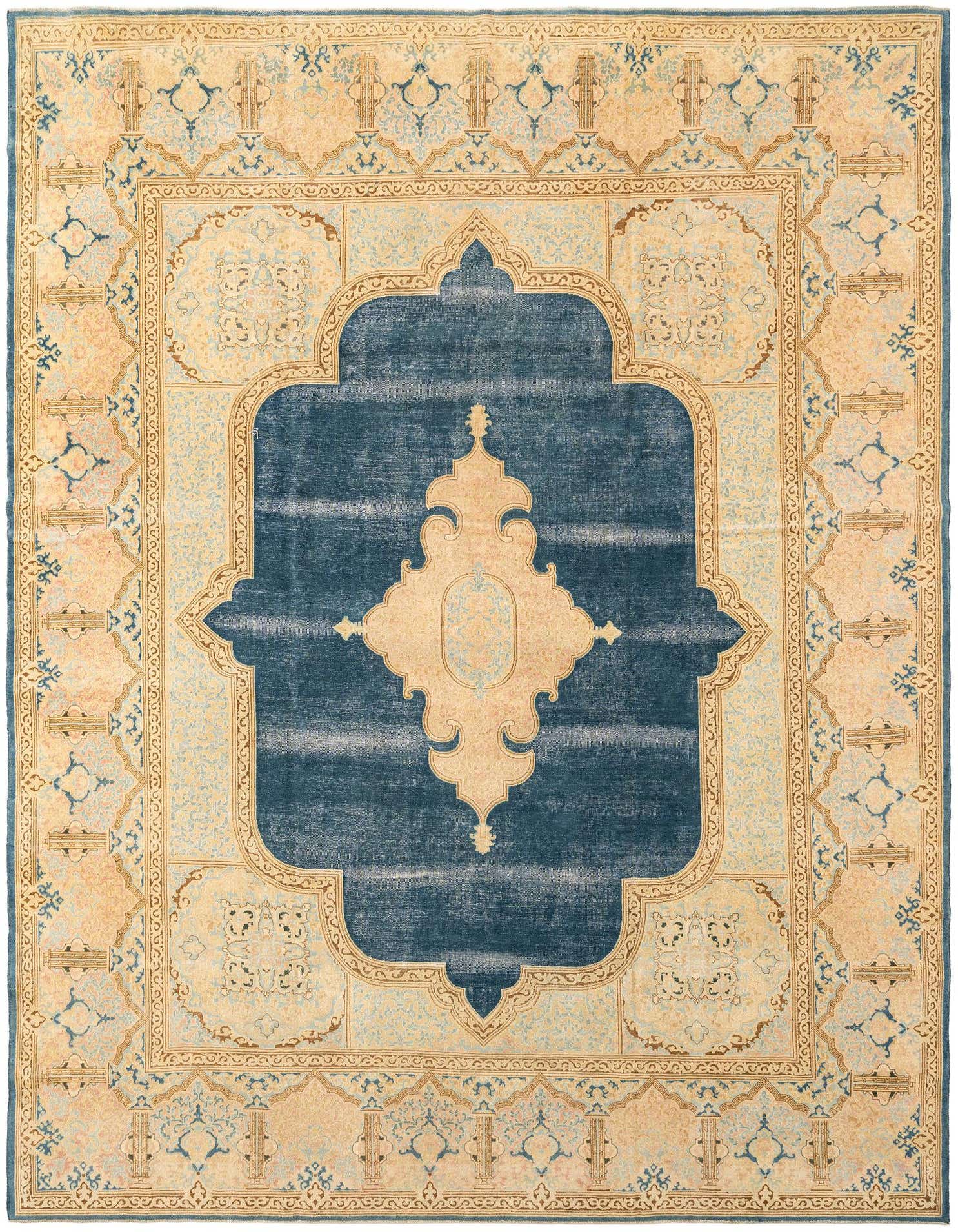 An 8x11 rectangular blue and beige wool rug with a distressed traditional pattern, featuring a large central medallion.