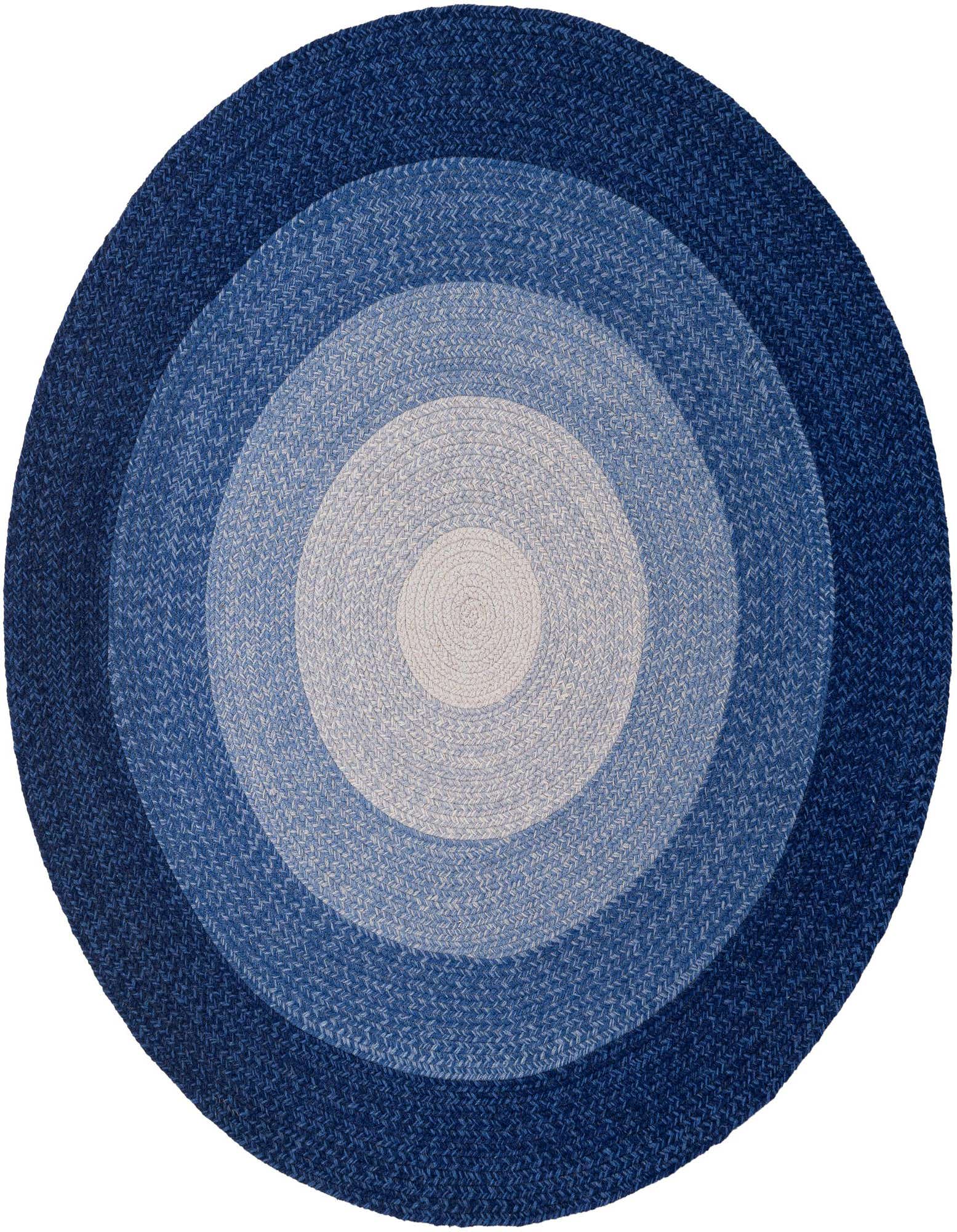 A round, braided wool rug featuring concentric circles in varying shades of blue, from light to dark.