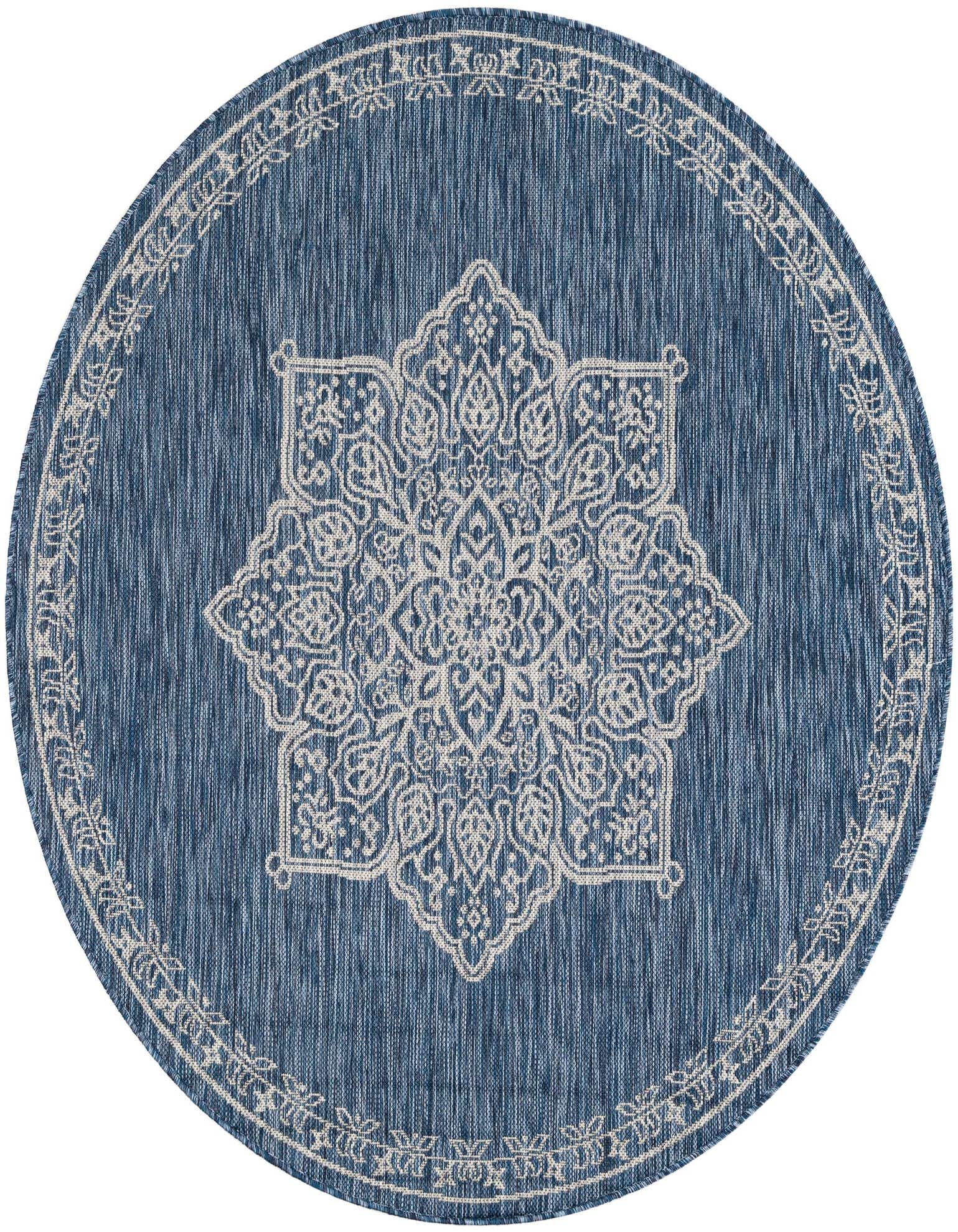 A 5' 3 round blue indoor/outdoor rug with a white traditional medallion pattern and border.