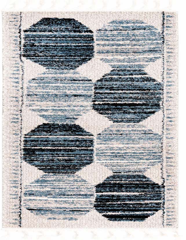 A 6 ft runner rug with a modern stripe pattern in varying shades of blue and black on a light cream background, featuring tassels.