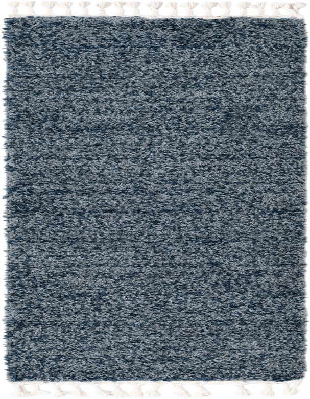 A soft blue shag runner rug with white braided tassels on each end, perfect for a hallway.