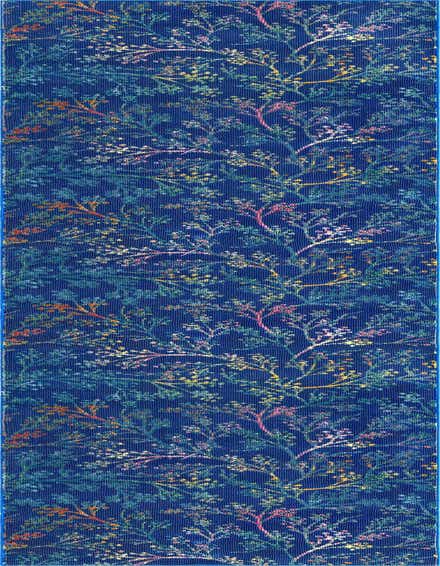 A 12 ft runner rug with a deep blue background and a vibrant, modern floral pattern featuring branches with colorful leaves and blossoms in shades of pink, yellow, orange, and teal.