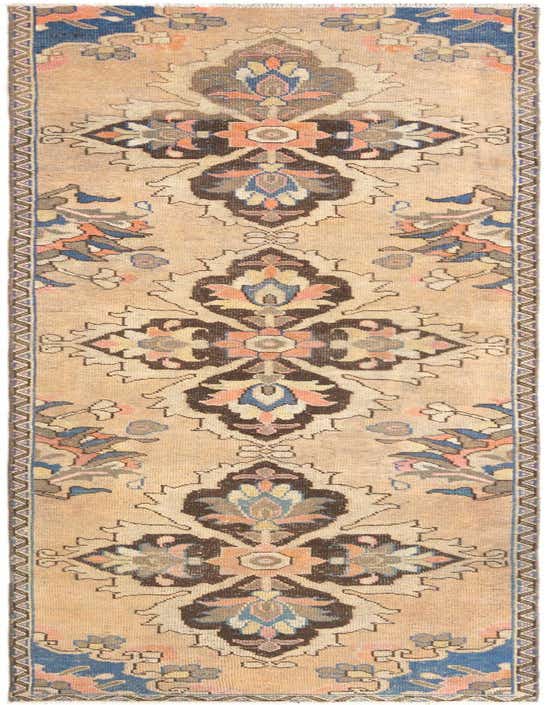 A 10 ft Hamedan runner rug with a traditional tribal pattern in blues, browns, and peach on a beige background, perfect for a hallway.