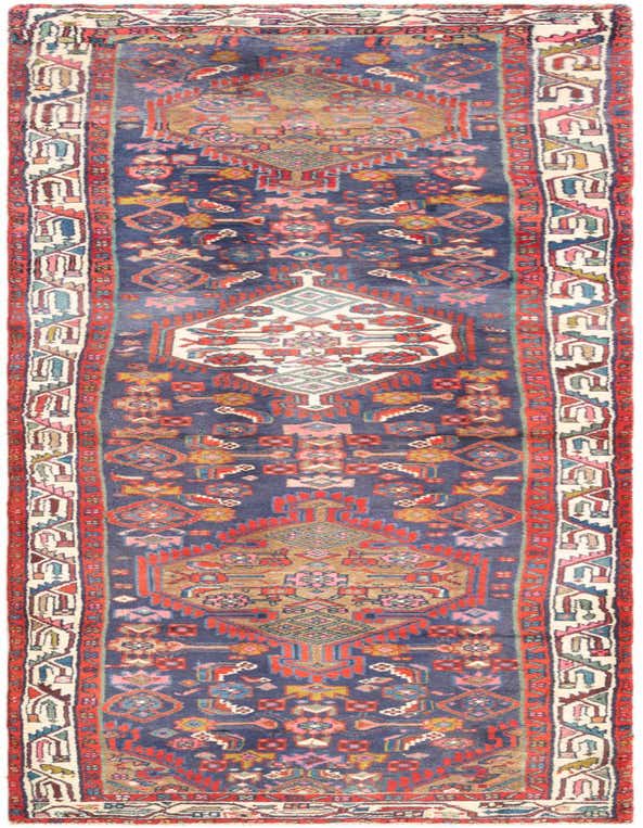 A 10 ft Hamedan wool runner rug featuring a tribal and traditional pattern in blues, reds, and creams, ideal for a hallway.